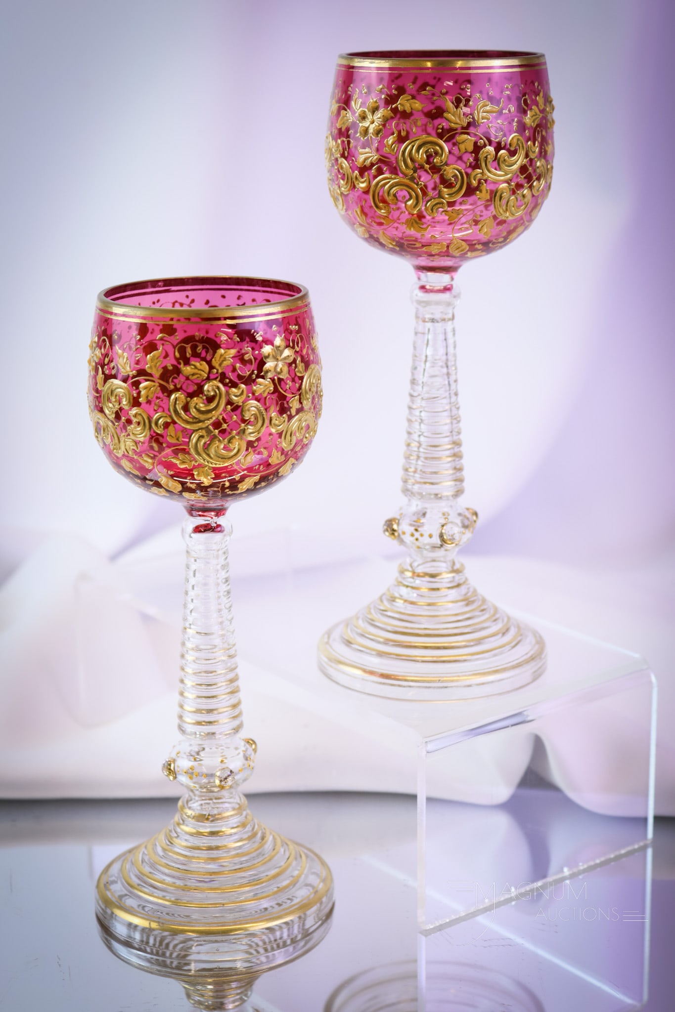 Pair Moser Cranberry Gilt Enameled Glass Victorian Roemers: A fine pair of Moser cranberry gilt and enameled glass Victorian roemers. Each has spiral stems. Each measures 7 3/4" tall and 2 1/2" wide. SHIPPING NOTICE: If you choose not to utilize the LiveAuctio