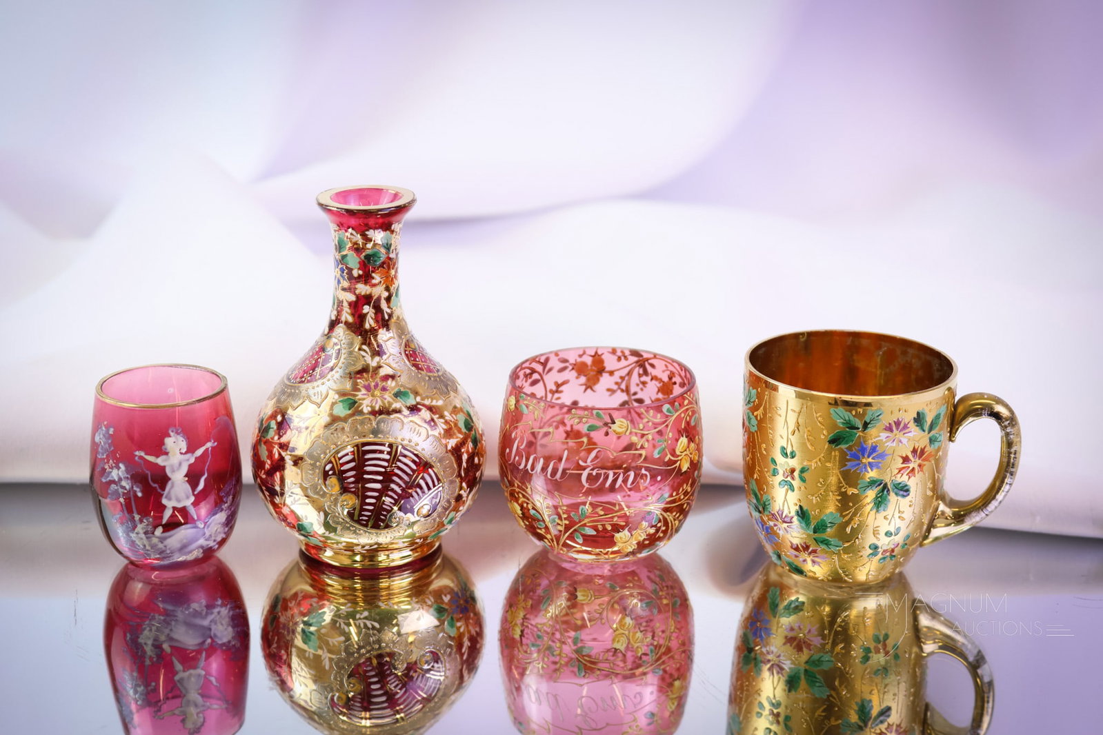 4 pc Lot Moser & More Miniature Art Glass Curiosities: Four little charming delights to pleasure your glass fancy. This lot combines pieces of Moser and the like. The lot includes a demitasse cup with all-over gold and enameled florals. A cranberry miniat
