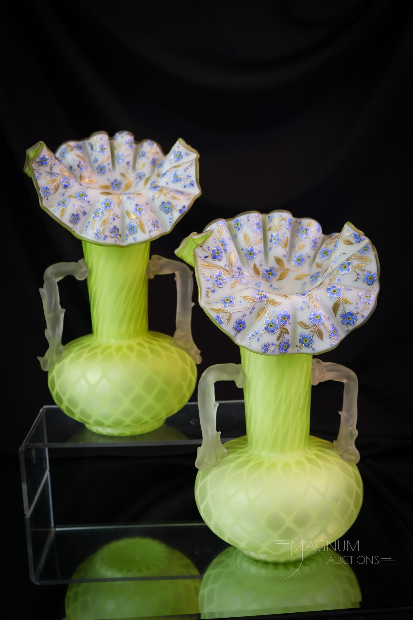 Pair Lime Green Victorian Enameled Mother of Pearl Satin Glass Vases: A lovely pair of Victorian satin diamond-quilt mantle vases. Each vase measures 10 1/4" tall and 5" wide. Each features applied glass thorny handles. The vases are decorated around the rim with blue v