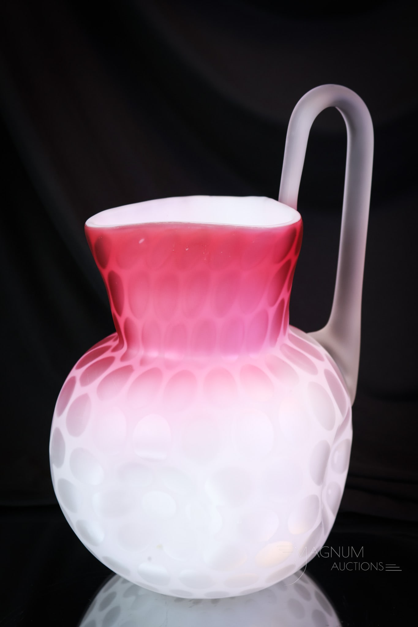 Victorian Phoenix Mother of Pearl Satin Glass Water Pitcher: Here's a fine Victorian glass water pitcher. This piece is attributed to Phoenix glass. It is in the coin spot or raindrop pattern. This pitcher has a high pulled up handle. The pitcher measures 10 1/