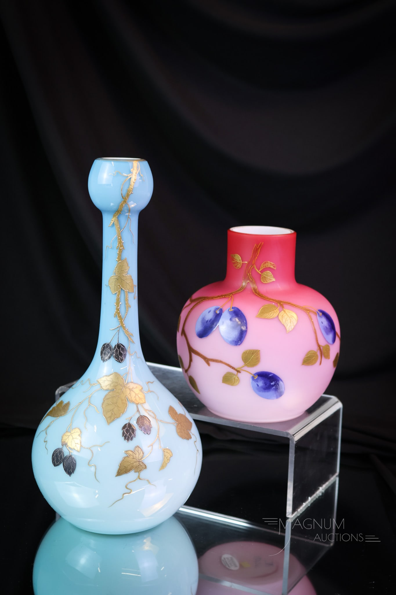 2 pc Lot Victorian Enameled Cased Glass Vases: Two fine examples of Victorian enameled cased glass. One in blue and one in pink. The tallest measures 10". SHIPPING NOTICE: If you choose not to utilize the LiveAuctioneers LiveShip program, MAGNUM A