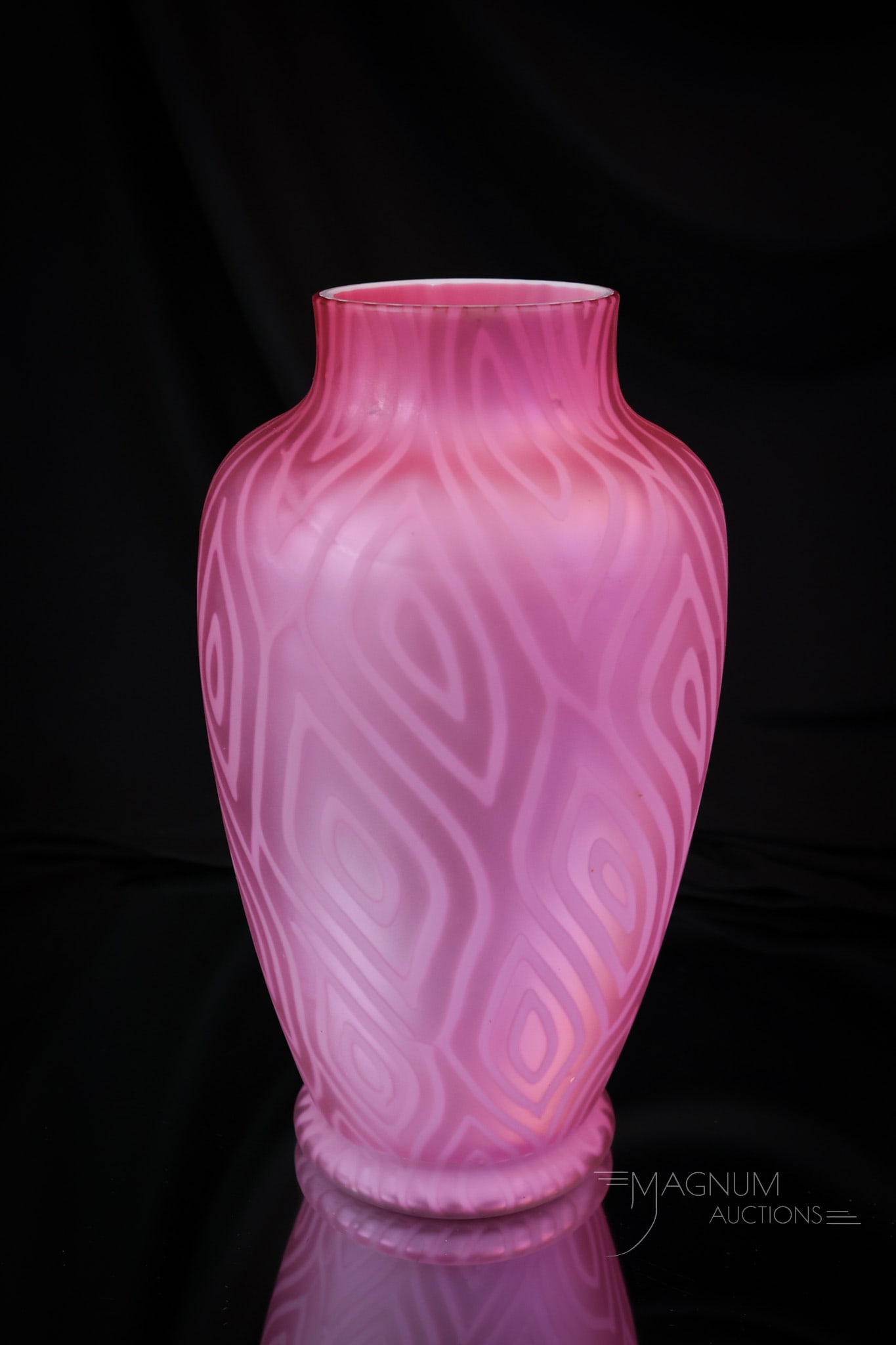 Victorian Pink Satin Mother of Pearl Moire' Glass Vase: A deep pink color Victorian satin glass vase. This piece is in a Moire pattern. The vase measures 9 1/2" tall and 5" wide. Two minor abrasions are noted on the shoulder of the vase. SHIPPING NOTICE: I