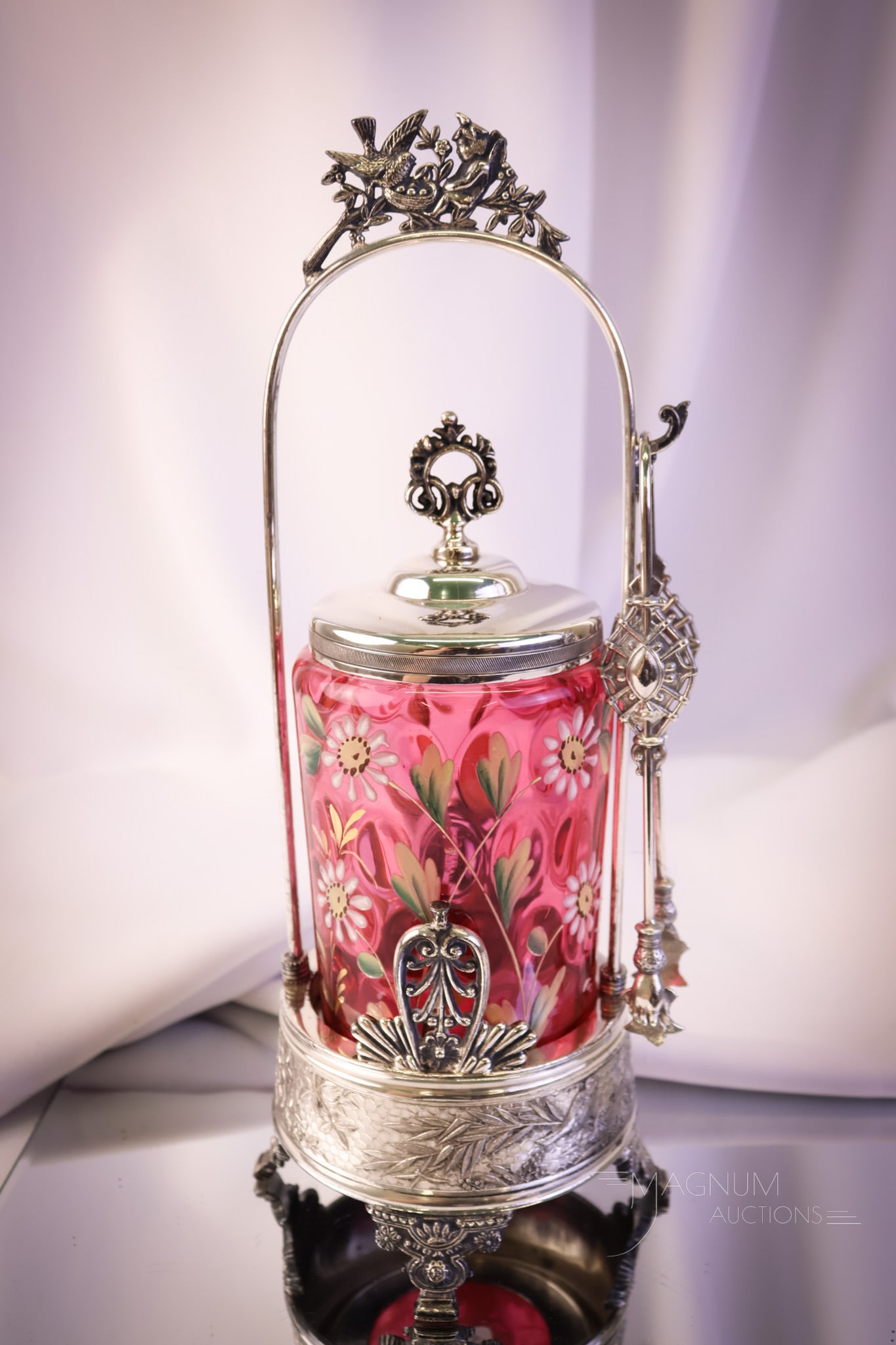 Rogers Victorian Silverplate Cranberry Enameled Glass Pickle Castor: A fine and collection-enhancing example of a wonderful Victorian pickle castor. This piece has a signed Rogers silverplate frame with a bird and cherub at the top and birds and a spiderweb around the 