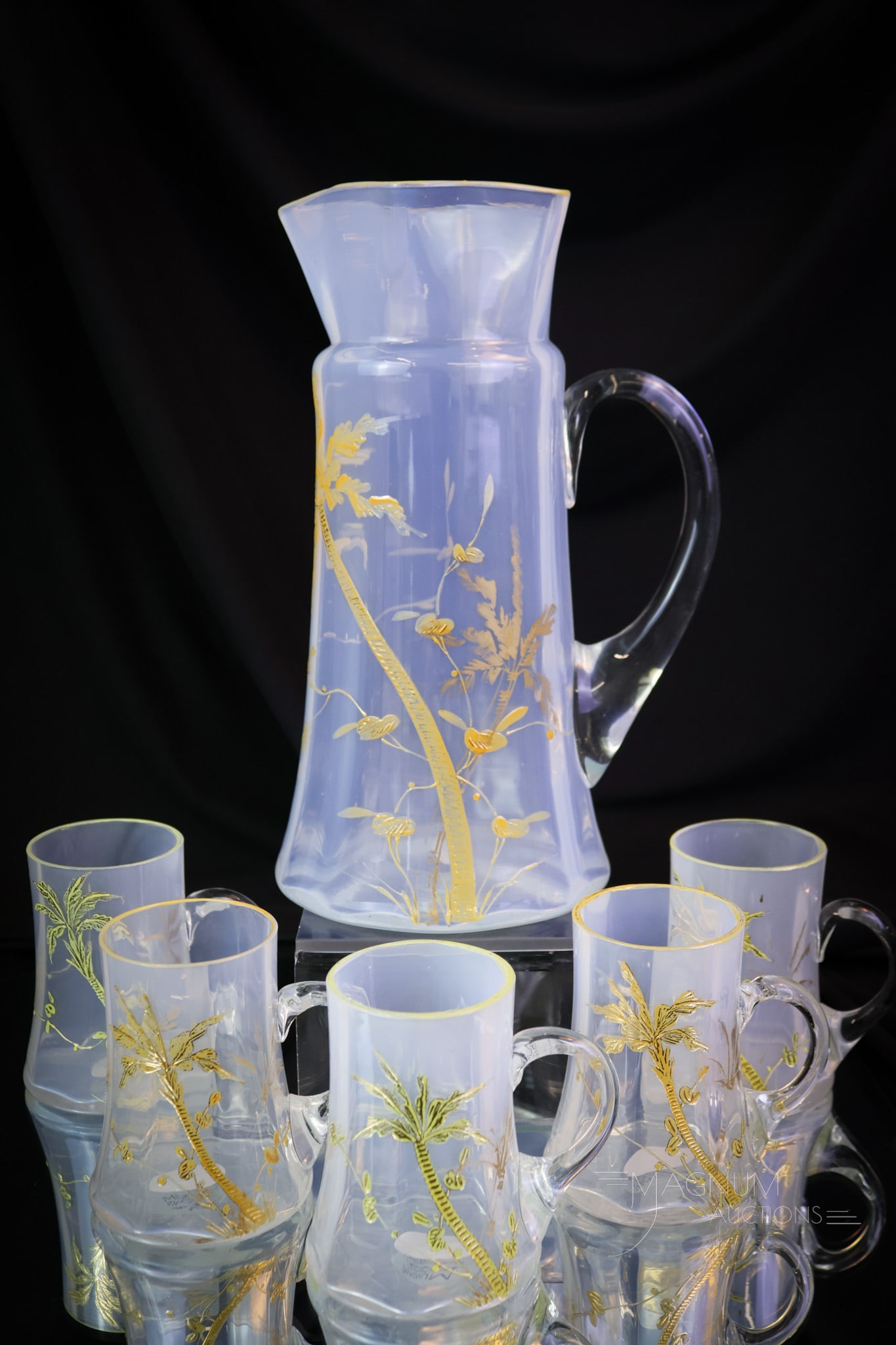 6 pc Set Victorian Gilt Opalescent Decorated Glass Water Set: A very pretty Victorian water set in decorated opalescent glass. This set features gilt enameled palm trees. There's a tankard pitcher and five little mugs. The tallest measures 10". SHIPPING NOTICE:
