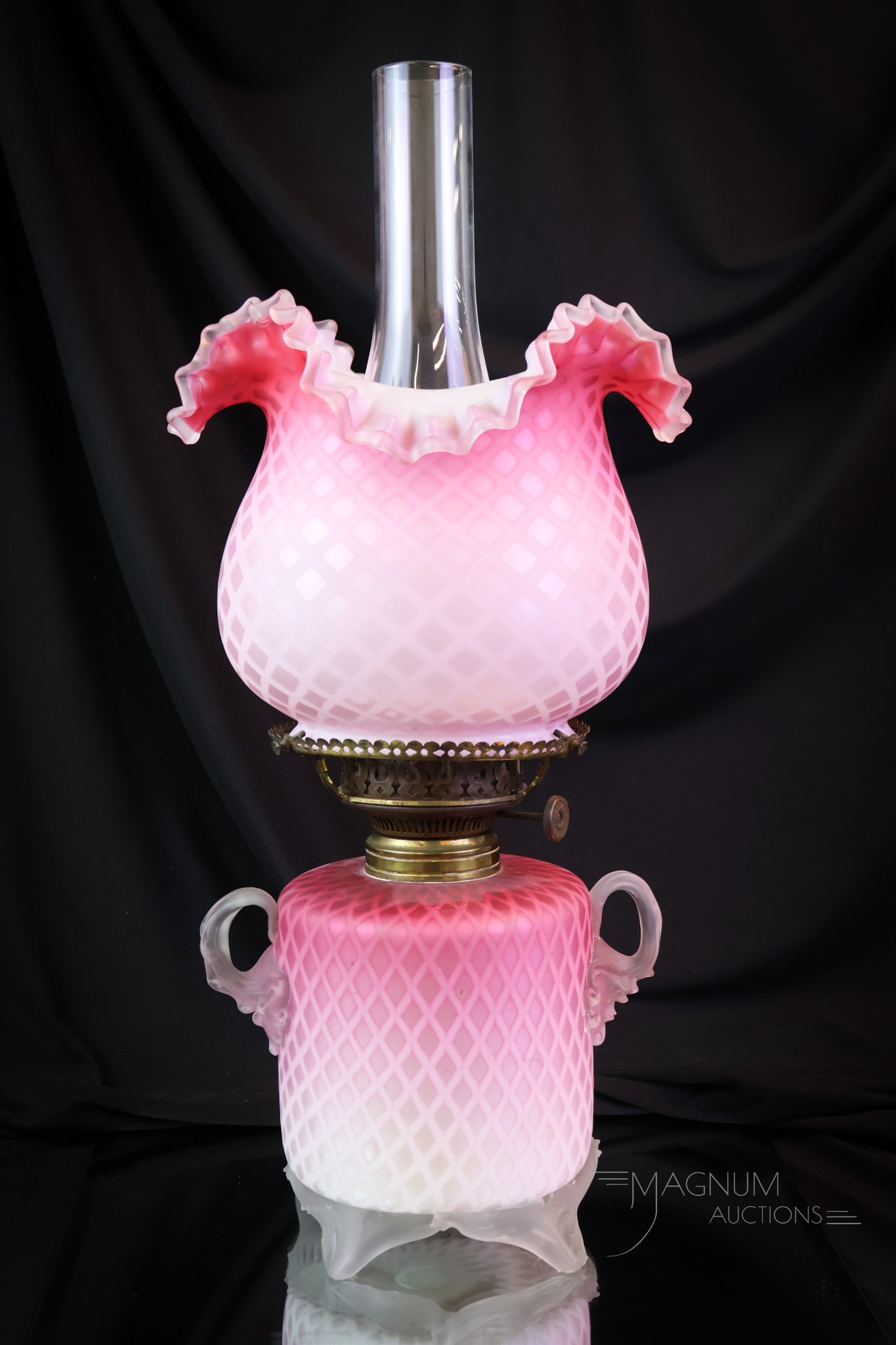 Victorian Pink Mother of Pearl Satin Glass Oil Lamp: A wonderful find in a Victorian pink satin mothe of pearl glass oil lamp. This lamp is complete with a matching bulbous shade. The base has dual-applied glass handles. The lamp measures 15 1/2" tall a