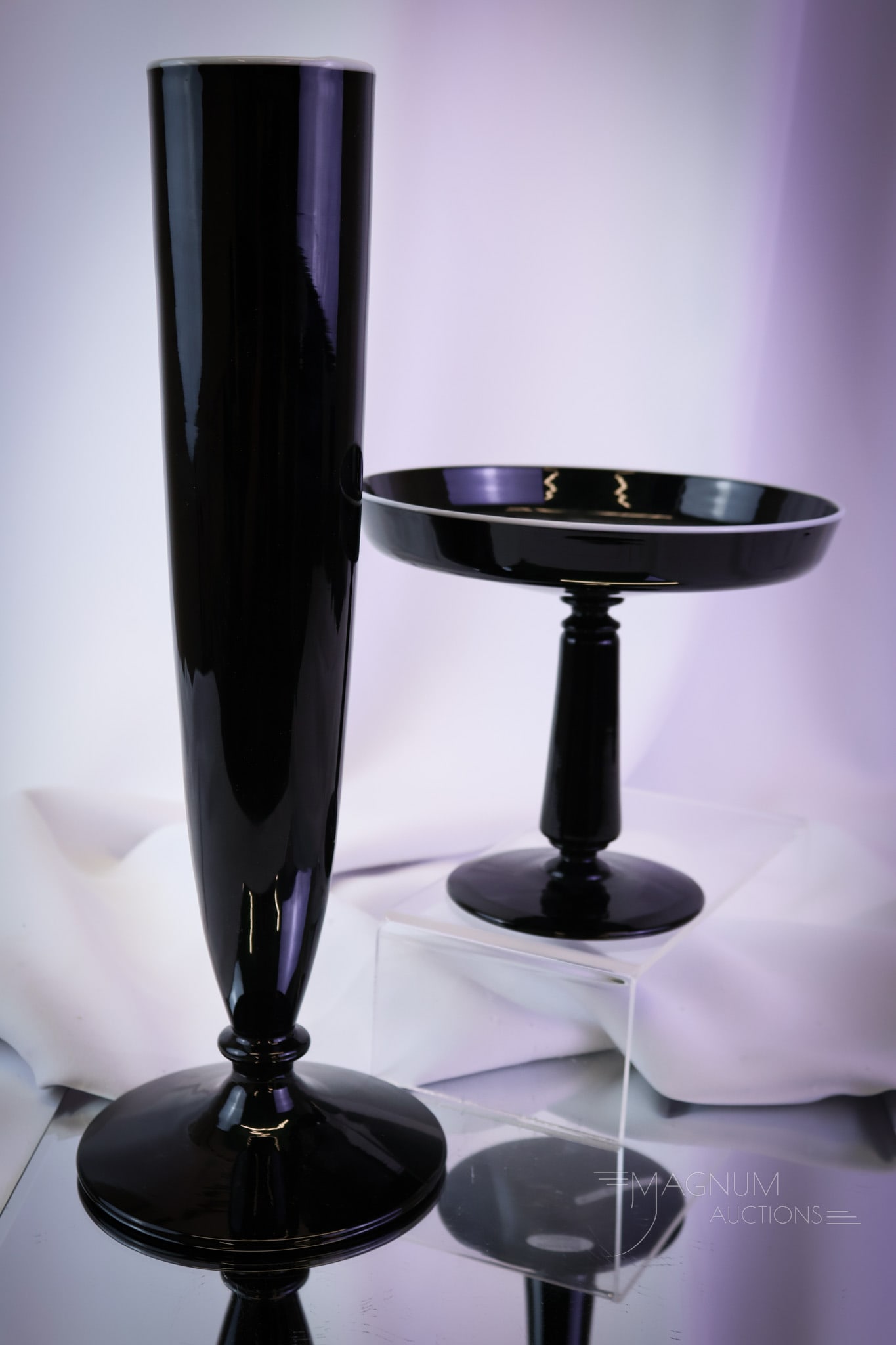 2 pc Lot Signed Sinclaire Art Deco Black Glass Vase & Compote: Two mirror black examples of signed Sinclaire Art Deco period glass. The lot is made up of a vase and a compote. Each has an applied white rim. The tallest measures 14". SHIPPING NOTICE: If you choose