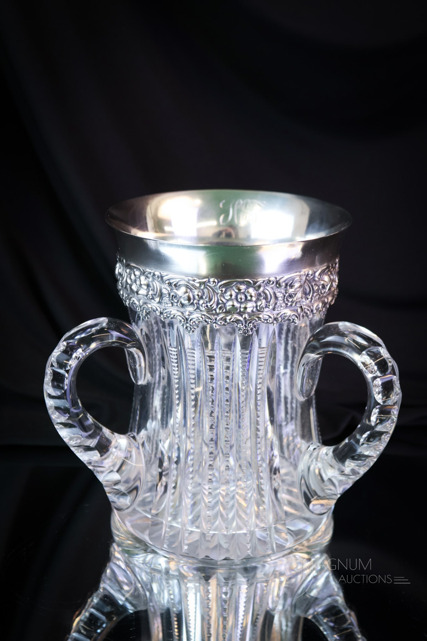 American Brilliant Period Cut Glass & Sterling Silver Loving Cup: A wonderful and attractive form and find in American Brilliant Period cut glass. This is a loving cup. The piece features three handles. It is complete with a sterling silver marked rim. This has repo