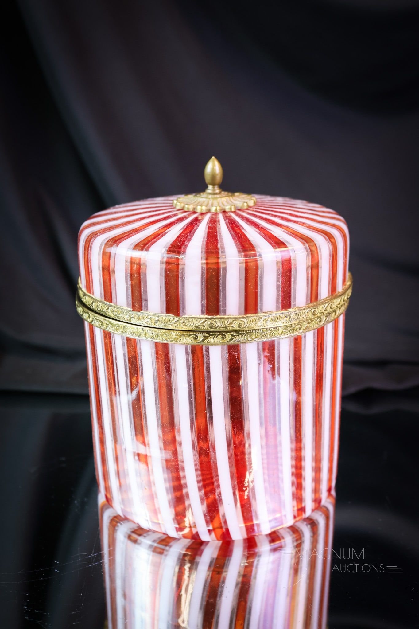 Italian Murano Ribbon Glass Jewelry Casket: A nice find for your collection. This is an Italian Murano art glass jewelry casket in ribbon glass. This piece has red and white stripes on clear. It is fitted with brass fittings. The piece measures