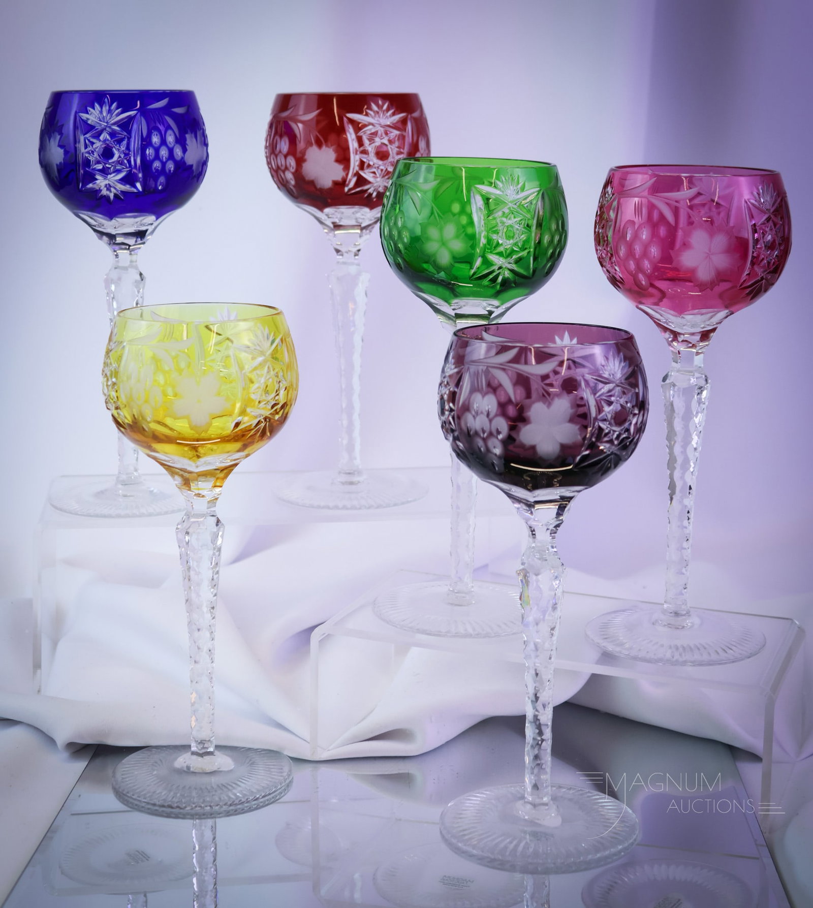 6 pc Set Bohemian Cut Overlay Glass Stems: Six colorful finds in Bohemian cut overlay colored stems. Each of these colorful stems is engraved with grapes. Each measures 8 1/2" tall. SHIPPING NOTICE: If you choose not to utilize the LiveAuction