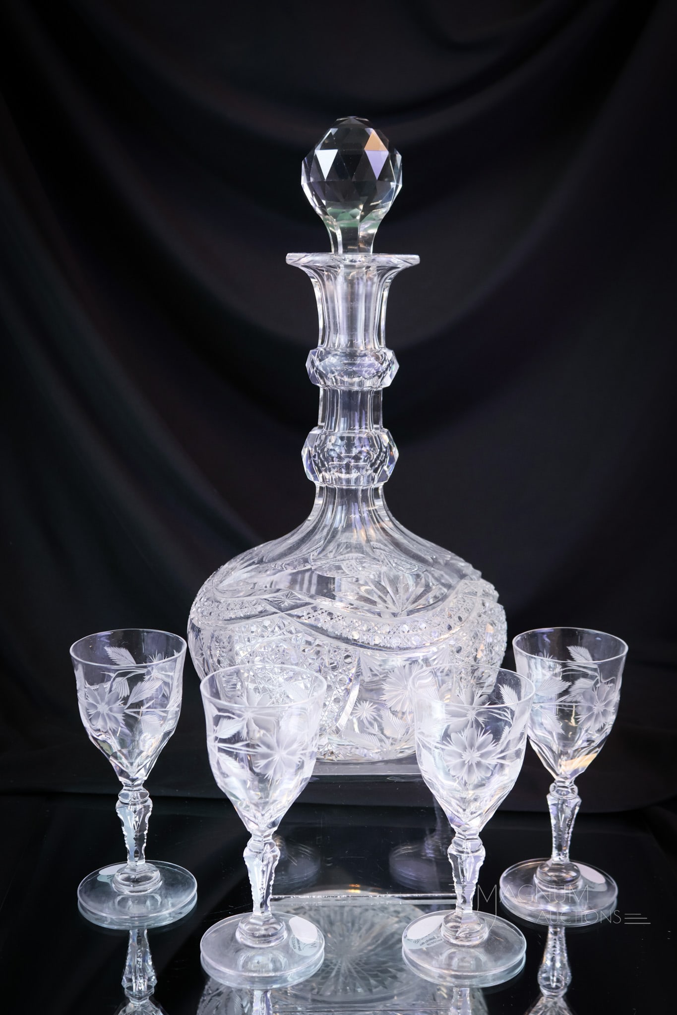 5 pc American Brilliant Period Cut Glass Decanter Set: A fine five-piece set in American Brilliant Period cut glass. The decanter is cut with arched swags of Daisy & Button and Hobstars. The stems are cut with matching floral engraving. The tallest of the
