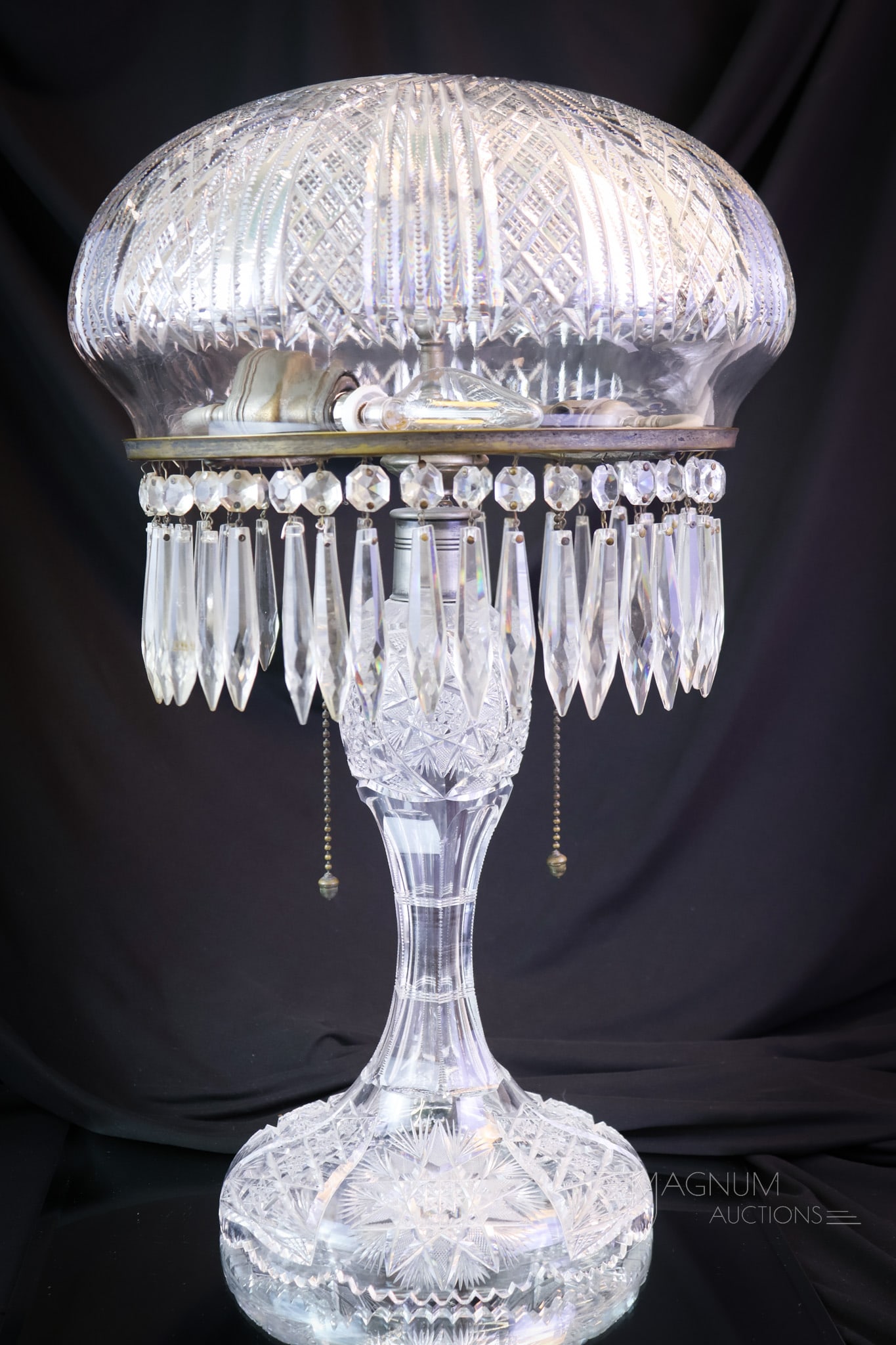 American Brilliant Period Cut Glass 20" Table Lamp: A gracious 20" tall and 12" wide American Brilliant Period cut glass table lamp. This lamp features beautiful cutting and is complete with the original sockets and fittings. Let this lamp brighten you