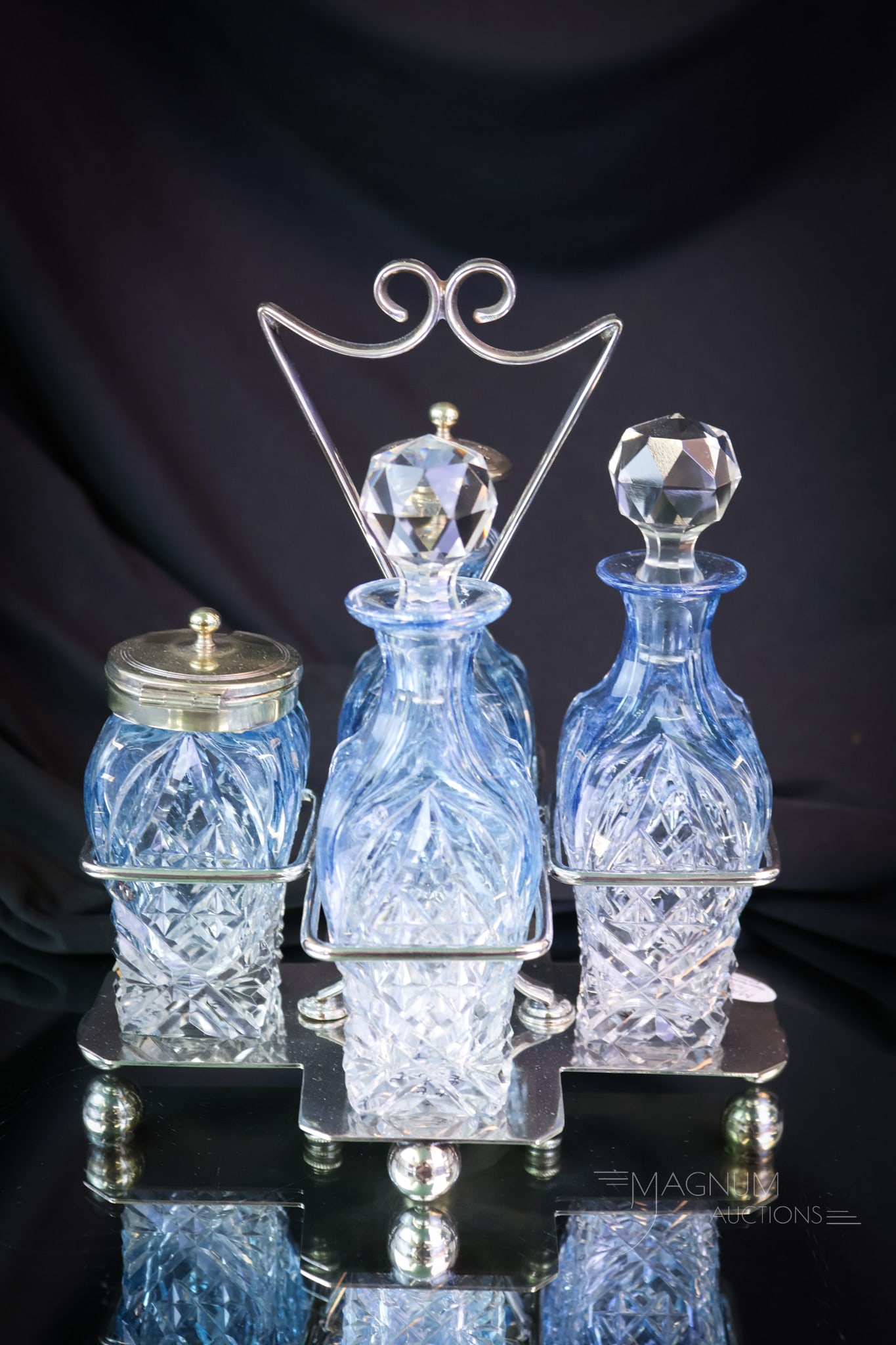 Briggs & Co. Sheffield Silverplate Blue Cut Glass Victorian Condiment Castor: What a wonderful find! This piece has striking coloring. This four-bottle condiment castor is set in a signed Briggs & Co. Sheffield silverplate holder. The set measures 8" tall. SHIPPING NOTICE: If y