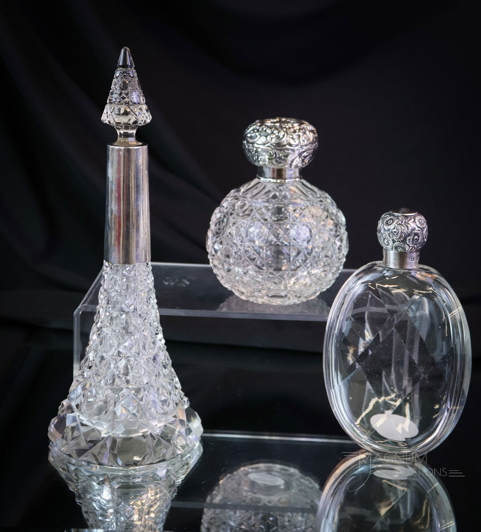 3 pc Lot Cut Glass Sterling Cologne Perfume Bottle Flasks: Three selections that are sure to be collection-enhancing! This lot offers a cut glass flask with a marked sterling silver repousse lid. A Cut glass ball-shaped perfume with a sterling silver hallmark