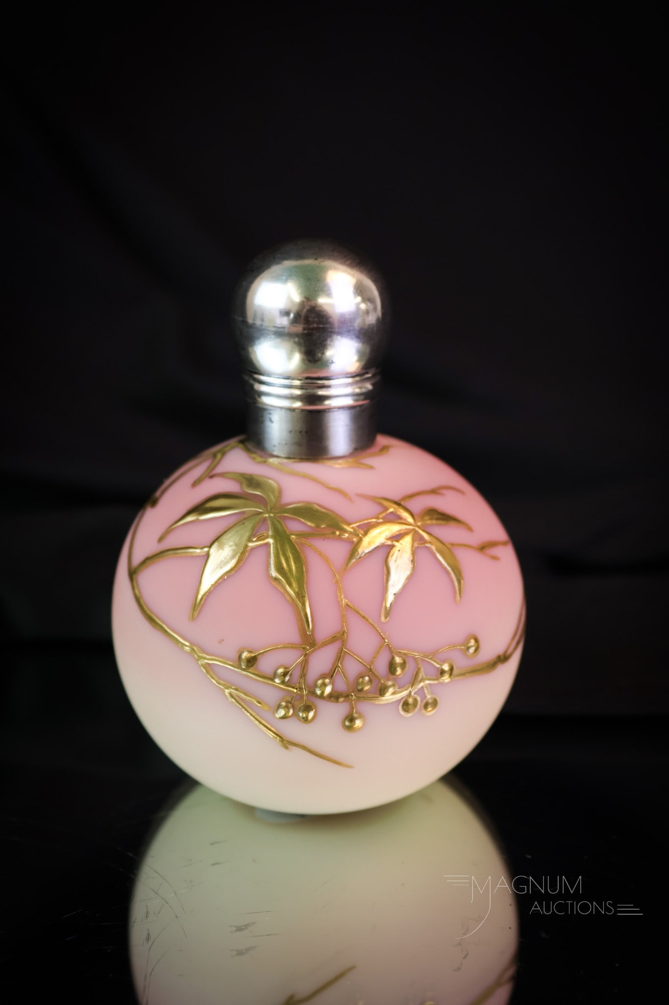 Victorian Thomas Webb Uranium Burmese Gilt Art Glass Perfume Bottle: Here's a uranium-rich Thomas Webb burmese glass perfume bottle. This little gem measures 3 1/2" tall and is found complete with a sterling silver top. This bottle is decorated in gold with leaves and