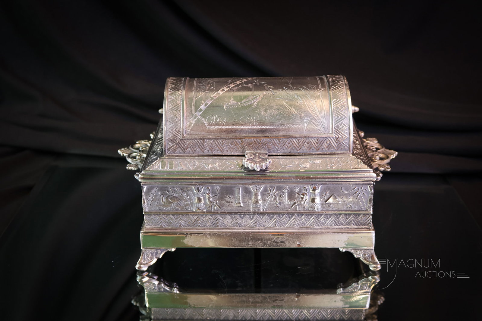 Victorian Silverplate Jewelry Casket: A beautiful piece of Victorian silverplate in the form of a jewelry casket. This piece features two pull-out drawers and a hinged lid on the top. The top features a chased scene of a boat, and the pie