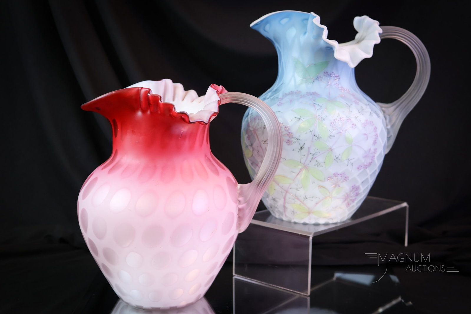 2 pc Lot Victorian Phoenix Glass Decorated & More Mother of Pearl Art Glass Pitchers: two beautiful and select finds for your collection. This lot offers two attributed to Phoenix glass water pitchers in the same form. One in pink and one in decorated blue. Each is lovely! The tallest 