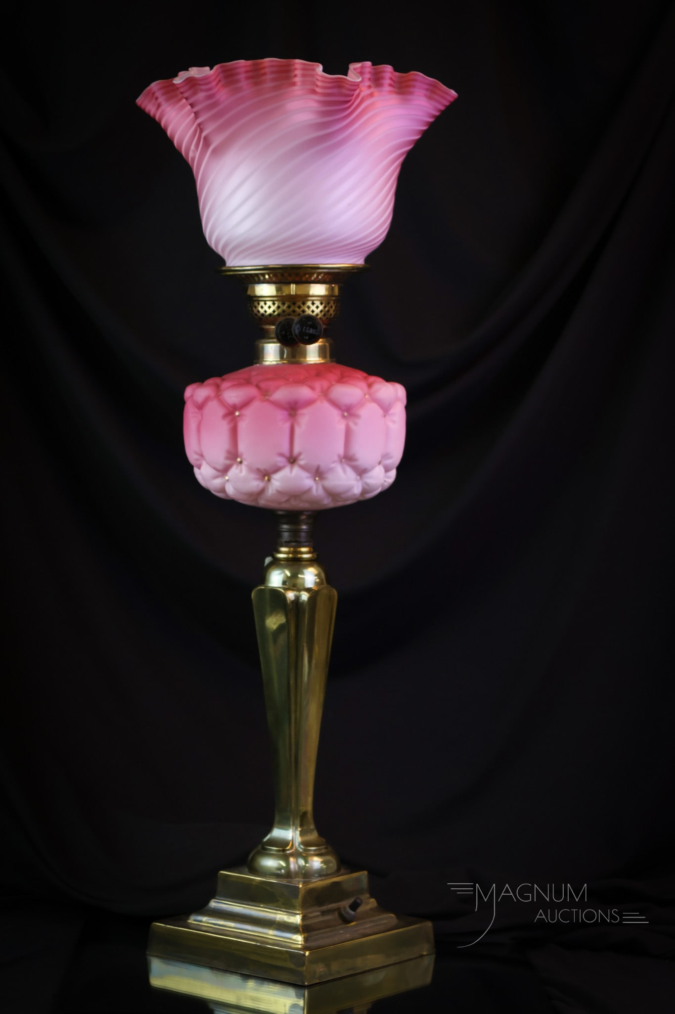 Victorian Pink Mother of Pearl Banquet Oil Lamp: A beautiful find in a Victorian banquet oil lamp. This lamp has been electrified. The lamp features a pink swirl mother-of-pearl shade. The font is a matching color of pink with a quilted design. The 