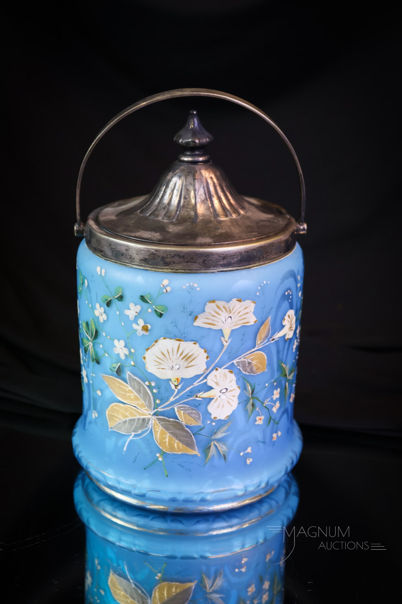 Blue Satin Mother of Pearl Peacock Eye Decorated Glass Biscuit Jar: A rich blue enameled glass biscuit jar from the Victorian period. This jar is in the Peacock Eye pattern. It is decorated with florals and retains the original mountings and lid. The jar measures 9" t