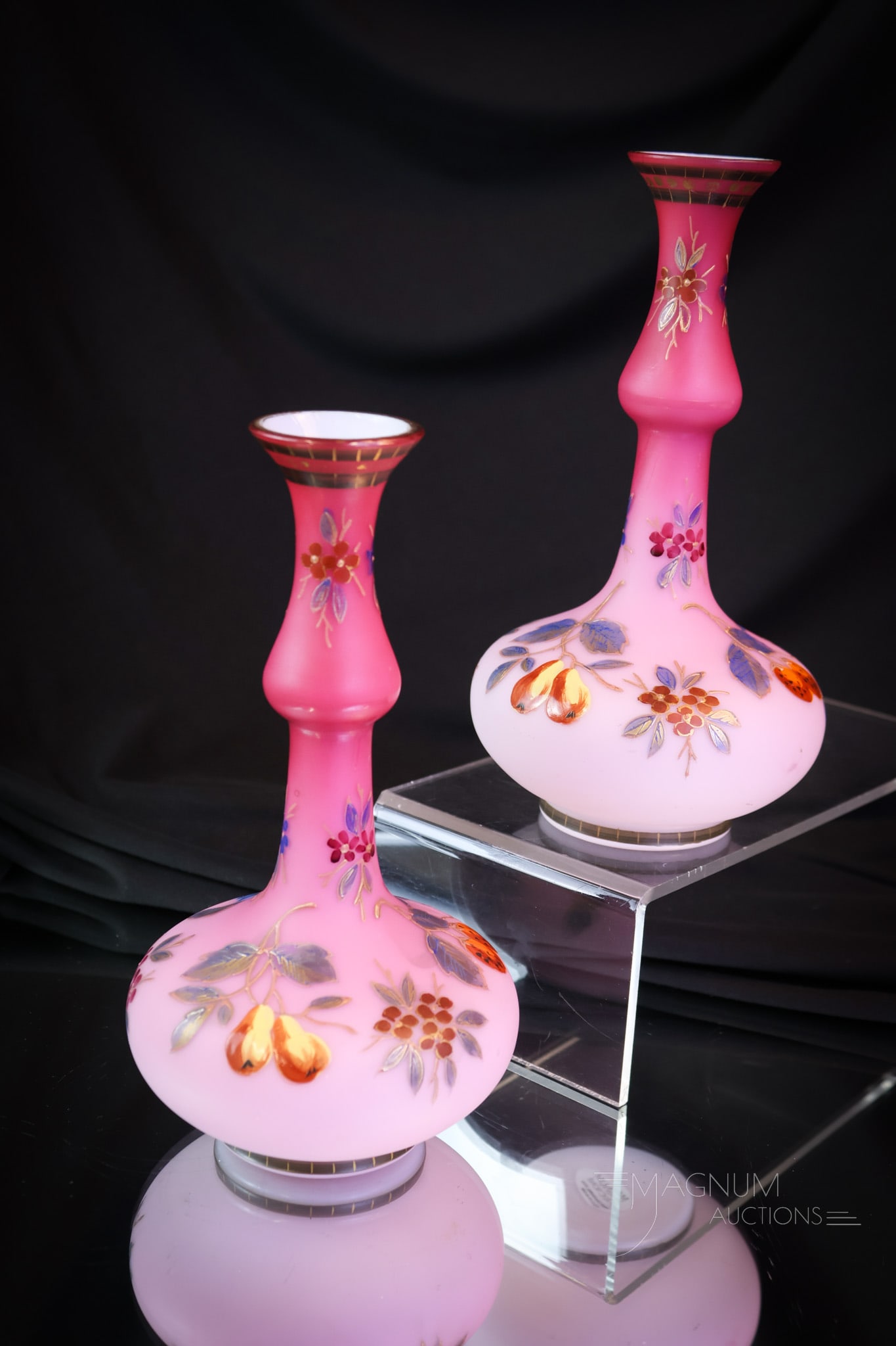 Pair Harrach Peachblow Enameled Satin Glass Mantle Vases: A beautiful pair of mantle vases in peachblow cased satin glass. These are attributed to Harrach. Each has a matching decoration of grapes, pears, and more. Each of these lovelies measures 7" tall. SH