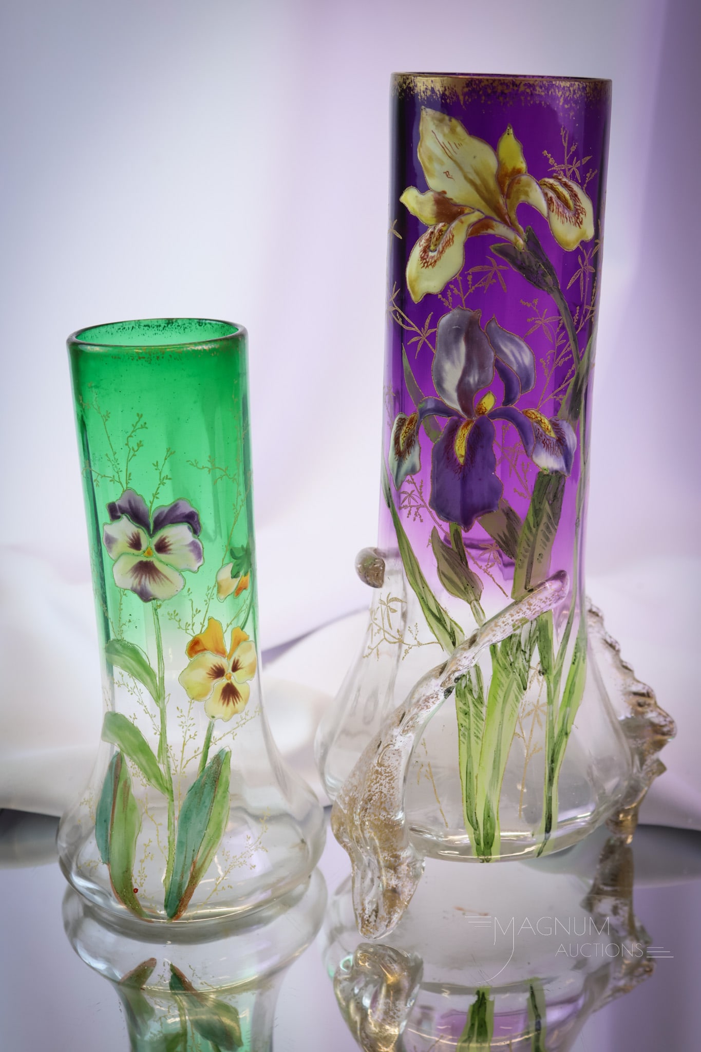 2 pc Lot Legras Mt. Joye Victorian Art Glass Vases: Two select finds in Victorian enameled art glassthat are attributed to Mont Joye or Legras. One is in green to clear glass with enameled pansies. The other is in purple to clear with applied feet and 