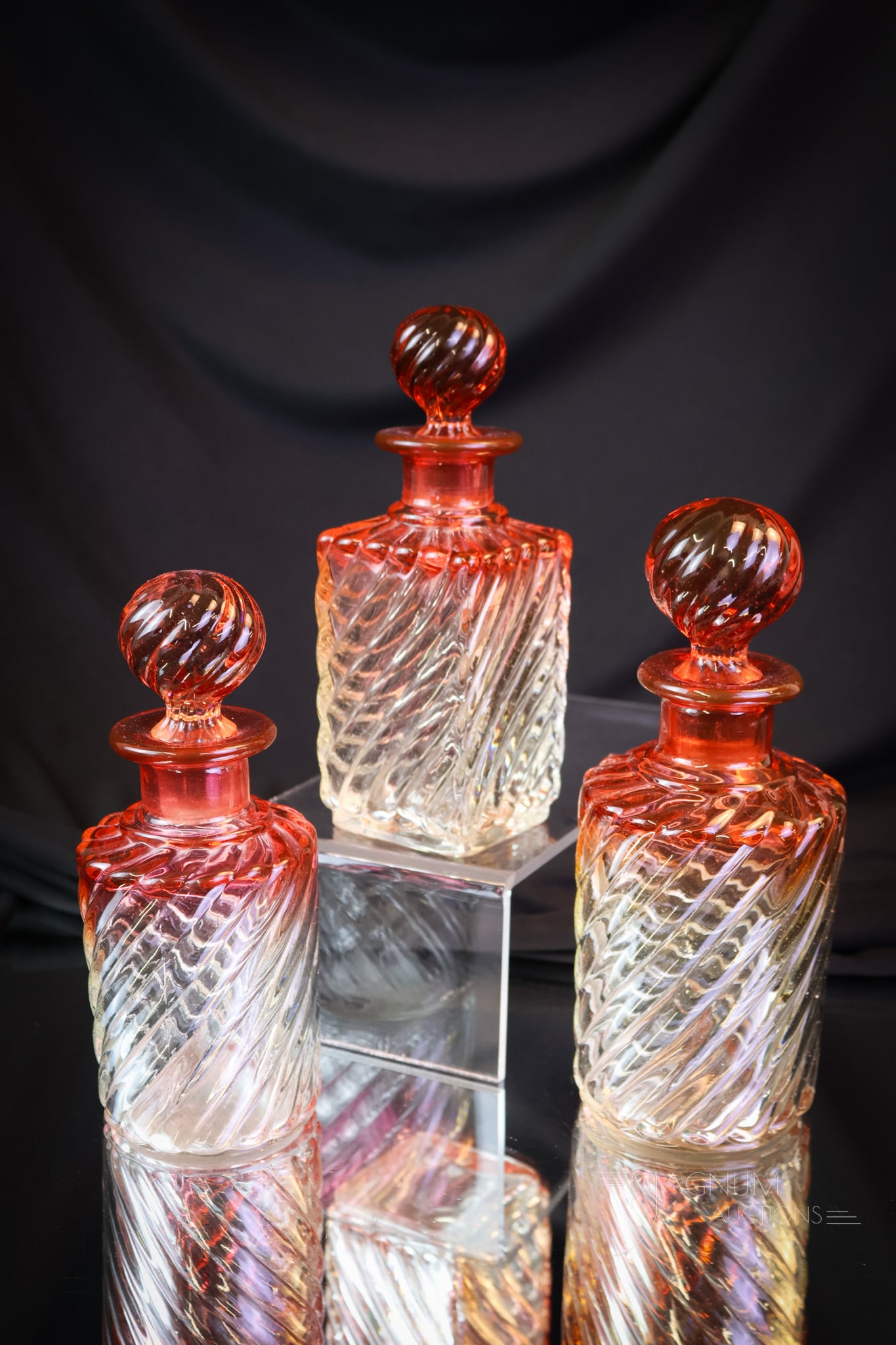 3 pc Lot Baccarat Rose Tiente French Crystal Cologne Bottles: Three selections for your Baccarat collection. This offering has three unique forms and sizes of cologne bottles. Each is in the Rose Tiente coloring. The tallest measures 7". SHIPPING NOTICE: If you