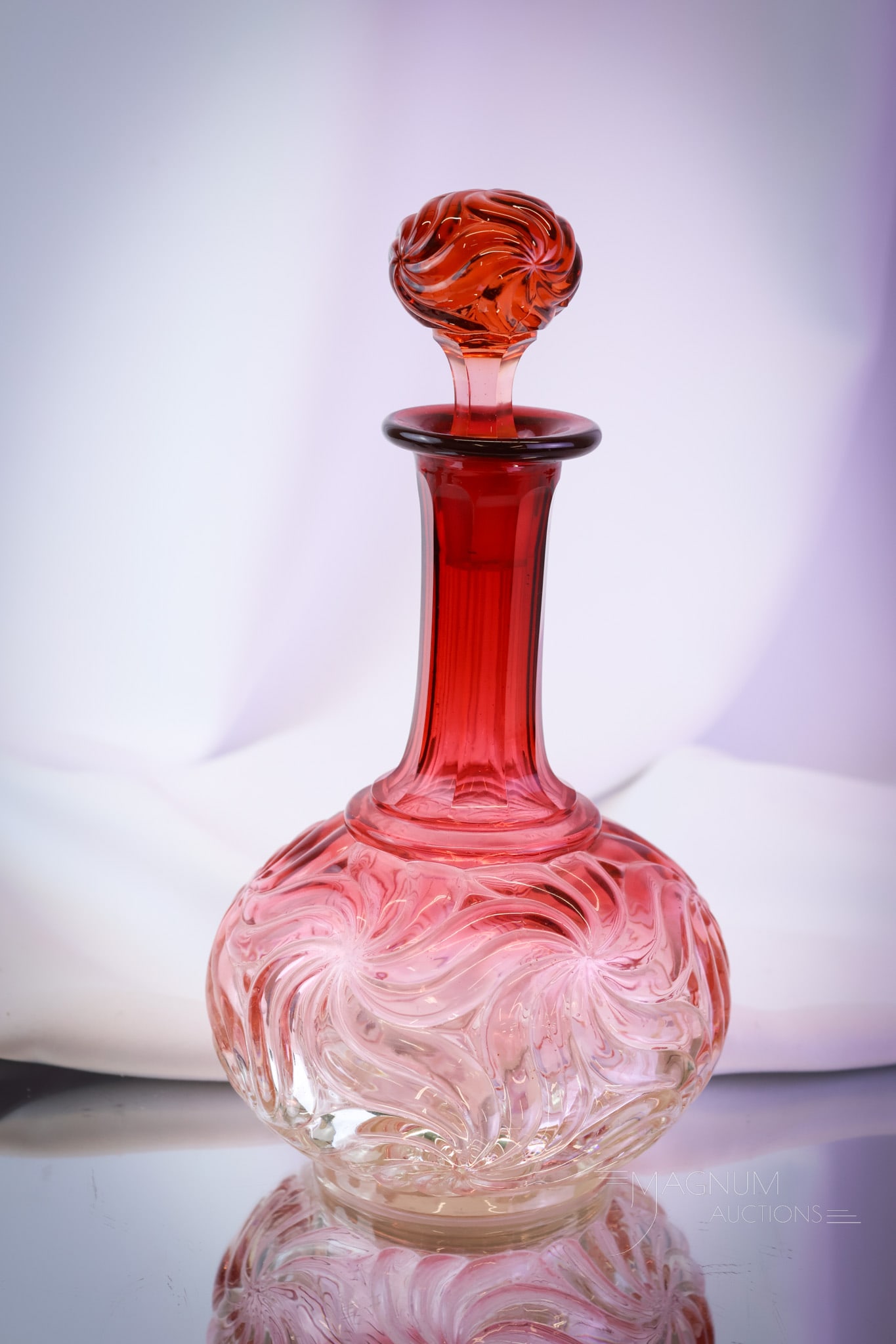 Baccarat Rose Tiente Pinwheel Swirl French Crystal Decanter: Gorgeous coloring is found on this Baccarat Rose Tiente Pinwheel Swirl pattern decanter. This piece retains its original matching stopper. The piece measures 10 1/4" tall. SHIPPING NOTICE: If you choo