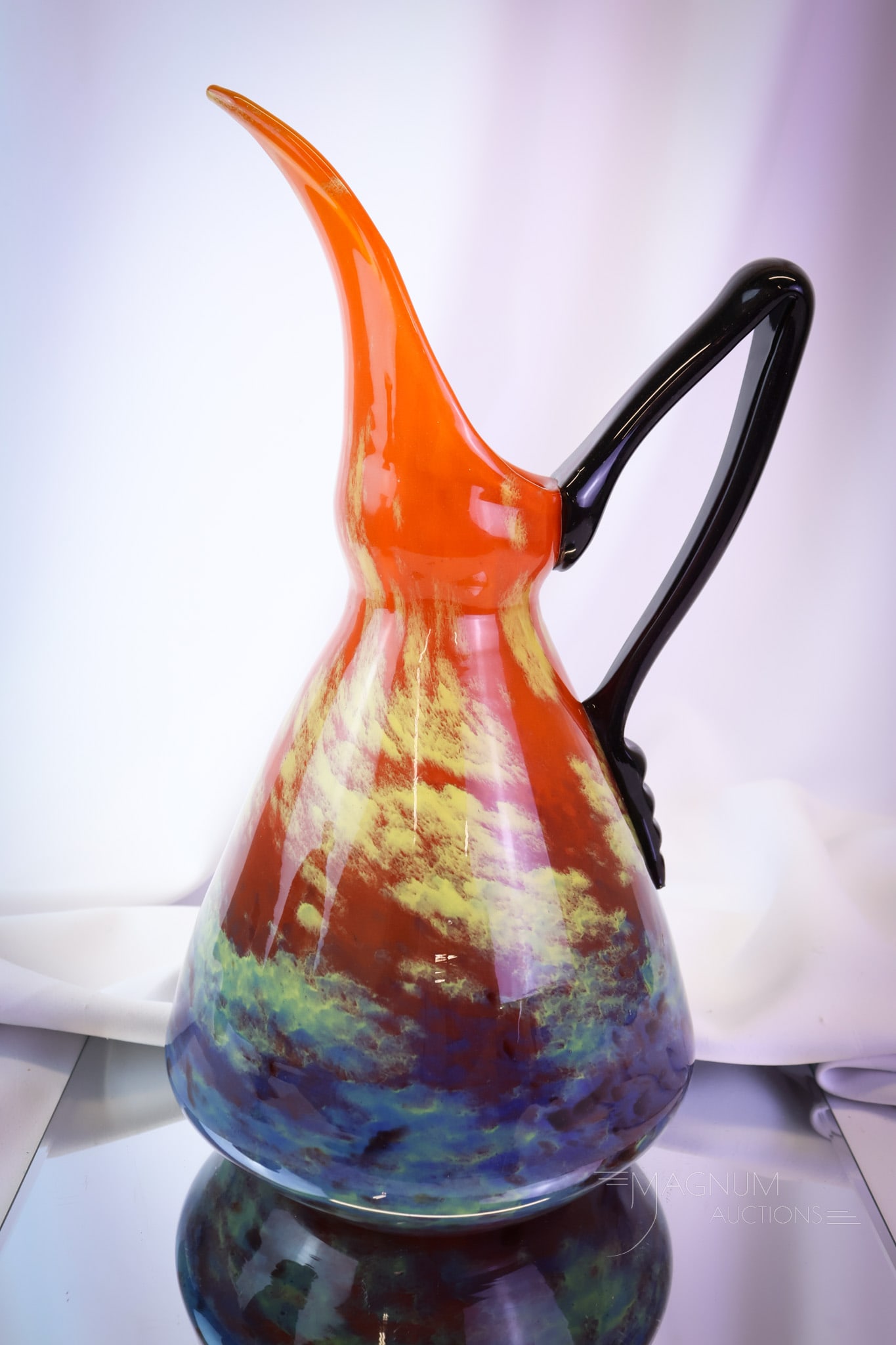 Signed Schneider Art Deco Mottled French Glass Pitcher: Another select find in signed Schneider French Art Deco glass. This is a pitcher with an applied deep purple handle. The pitcher body is a mottled glass in orange, yellow, and blue. This superior exam