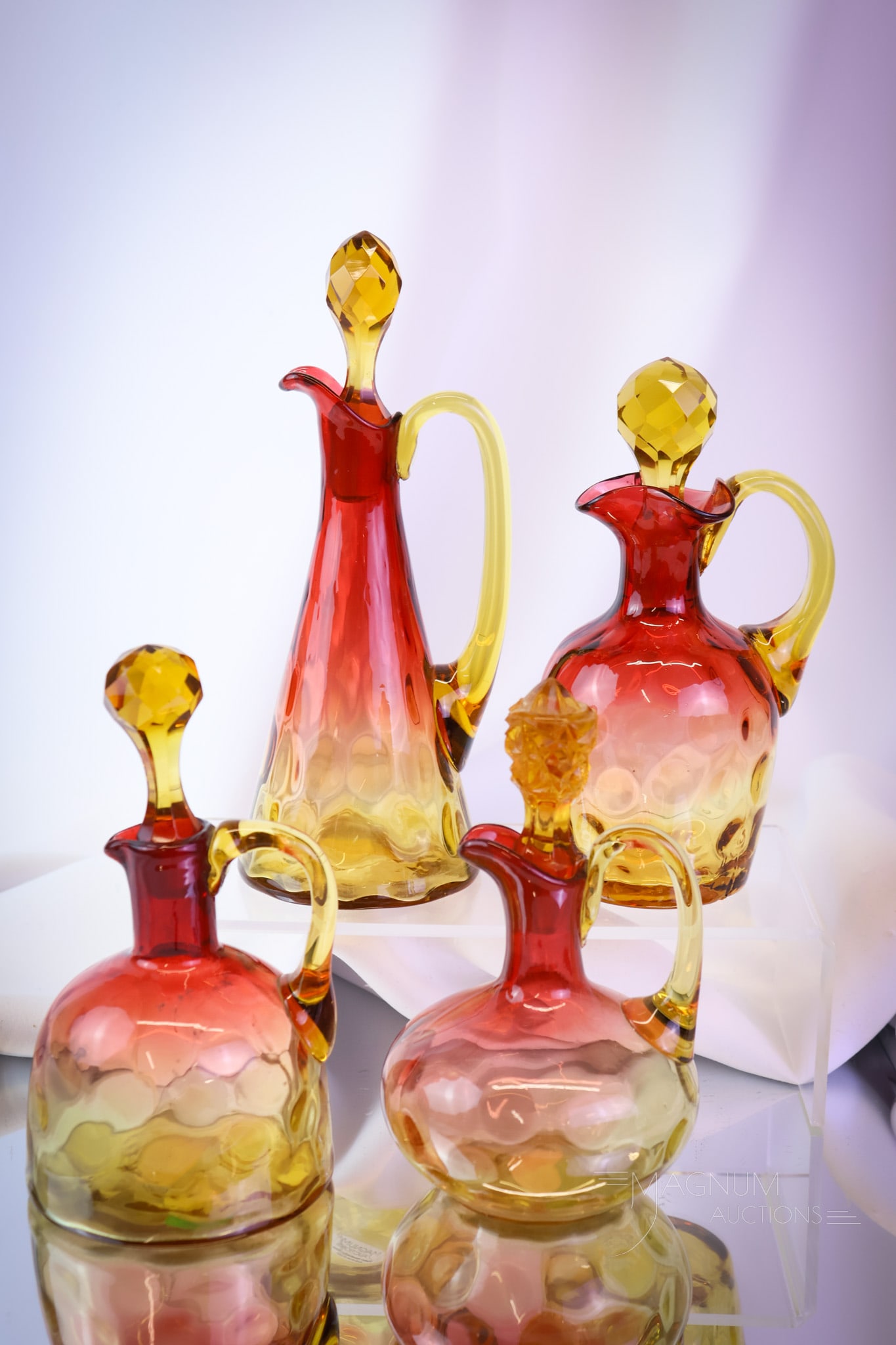 4 pc Lot Victorian Amberina Art Glass Cruets: A nice array of Victorian amberina glass cruets. Each is in the inverted thumbprint pattern. The tallest measures 8". SHIPPING NOTICE: If you choose not to utilize the LiveAuctioneers LiveShip program