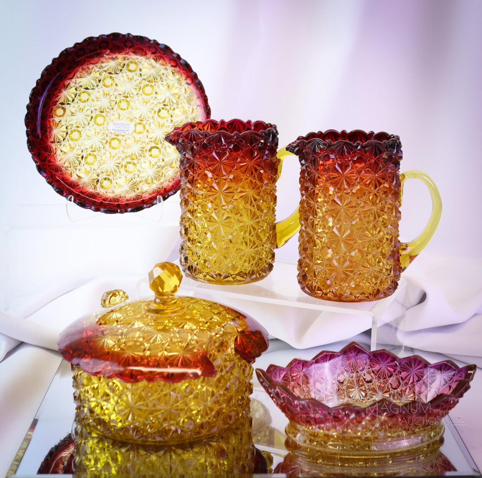 5 pc Lot Hobbs Daisy & Button Victorian Amberina Glass: Five nice and collectible finds in Victorian Hobbs glass. This lot includes 2 creamers, an oval small bowl, and a butter tub with a plate. The tallest measures 5" tall. The plate exhibits some chips a