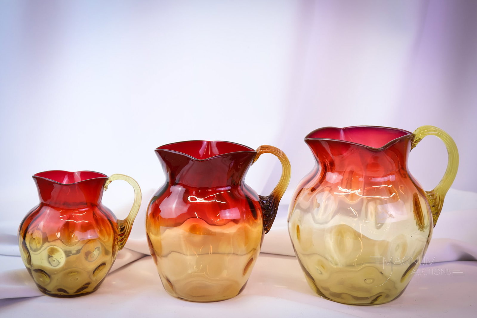 3 pc Lot Mt. Washington Victorian Amberina Glass Pitcher Set: Three graduated sizes of Victorian Mt. Washington amberina glass pitchers. This lot is a must-have selection for your Victorian glass collection! The tallest measures 6 1/2". SHIPPING NOTICE: If you c