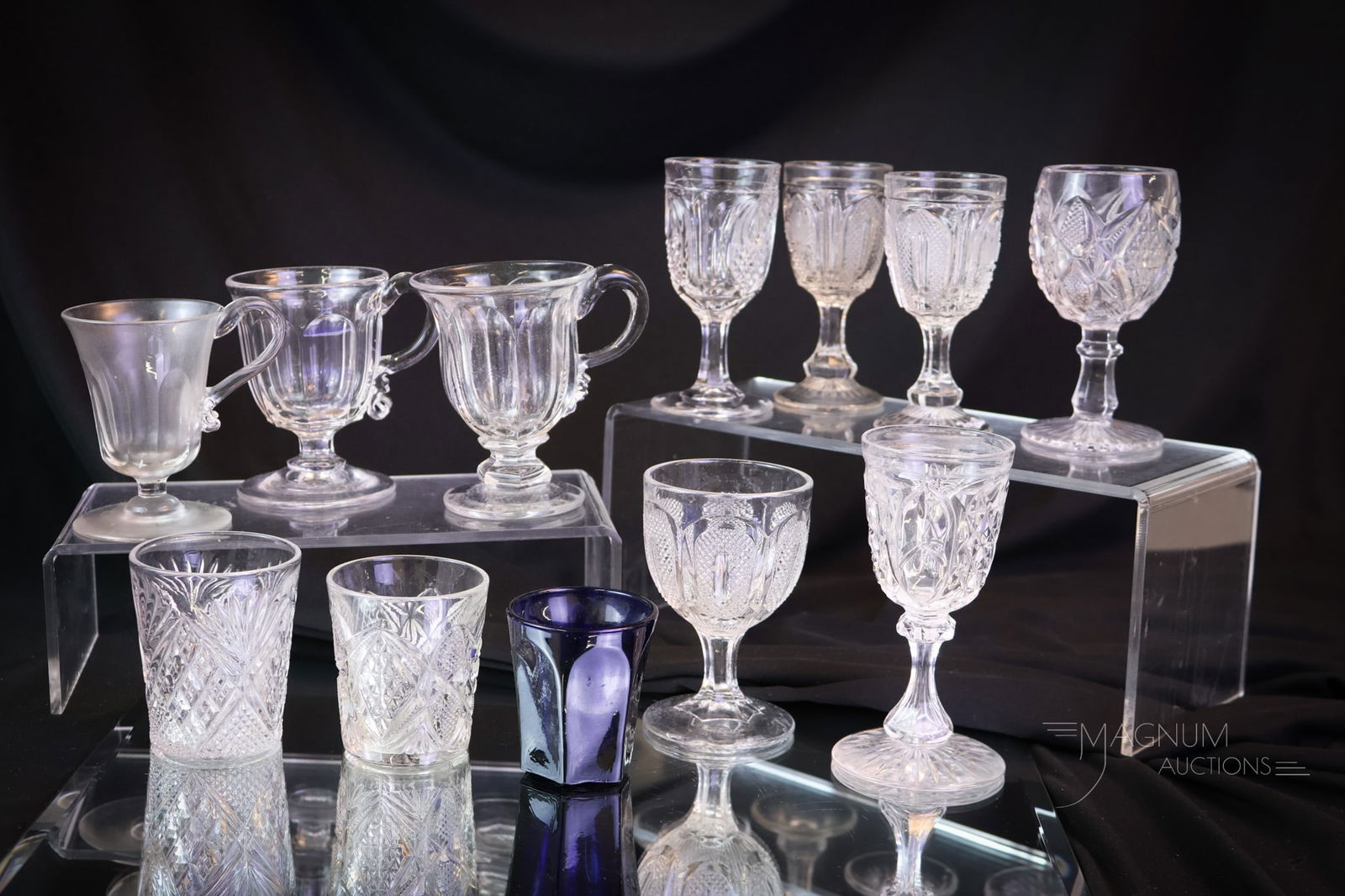 12 pc Lot Early EAPG Flint and More Glass: Twelve desirable finds in early flint and pattern glass. This lot combines five flint cordials, three mugs, two shot glasses, an EAPG cordial, and a cobalt shot glass. The tallest measures 4 1/2". Pro
