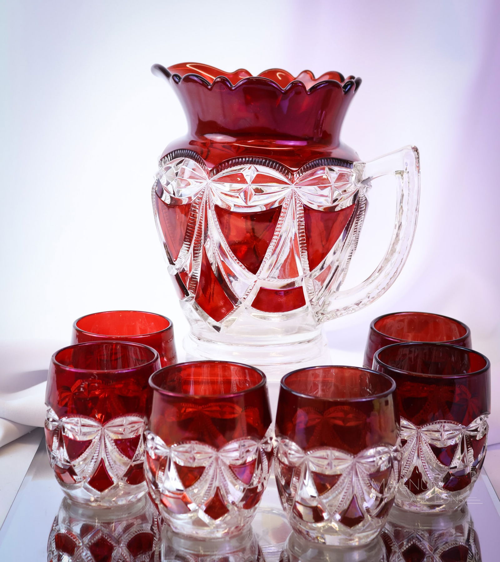 7 pc Set Riverside Victorian Ruby Stained Victoria Water Set: A beautiful find in Riverside Victorian ruby-stained glass. This is a complete seven-piece water set in the Victorian pattern. A showy and desirable set. The tallest of the offerings measures 7 1/2".