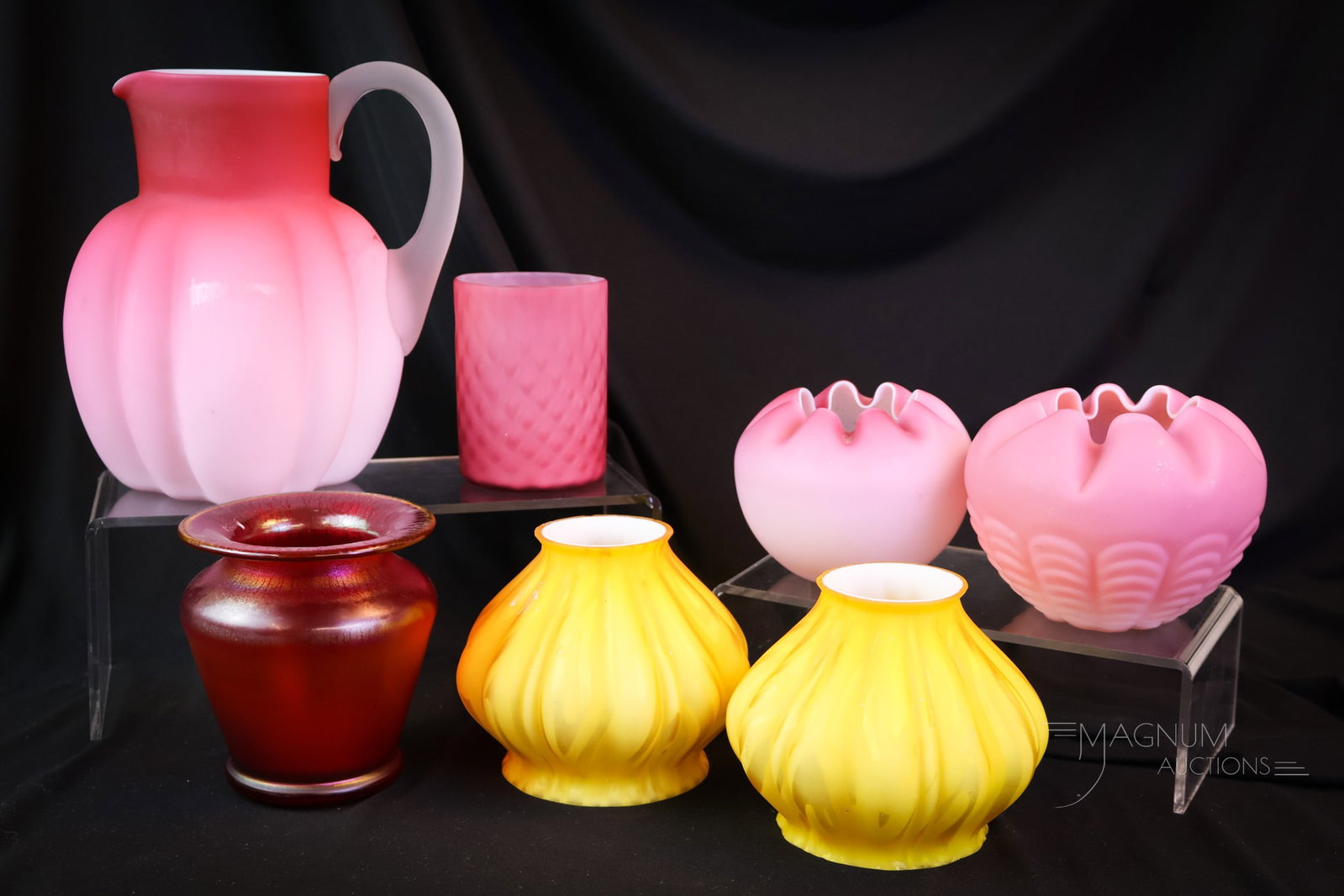 7 pc Lot Victorian & More Art Glass: Seven delights for your bidding pleasure. This lot includes four pieces of Victorian pink satin glass. A red stretch glass vase. A pair of gold mother-of-pearl art glass shades. The tallest measures 7