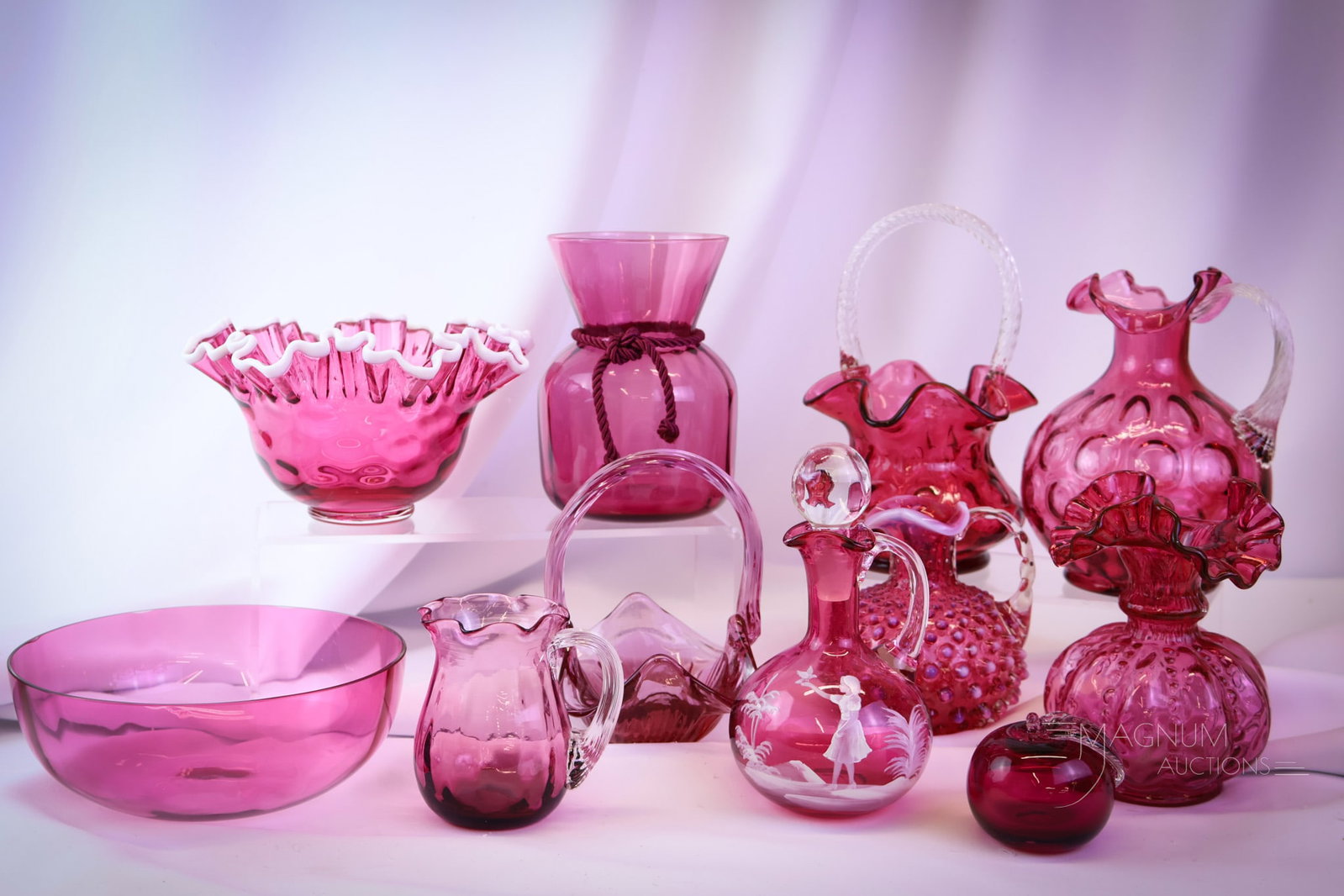 11 pc Lot Collectible Cranberry Glass Fenton and More: Eleven finds in cranberry glass that a sure delight. This lot includes various collection-enhancing finds. The tallest measures 8 1/2" tall. SHIPPING NOTICE: If you choose not to utilize the LiveAucti