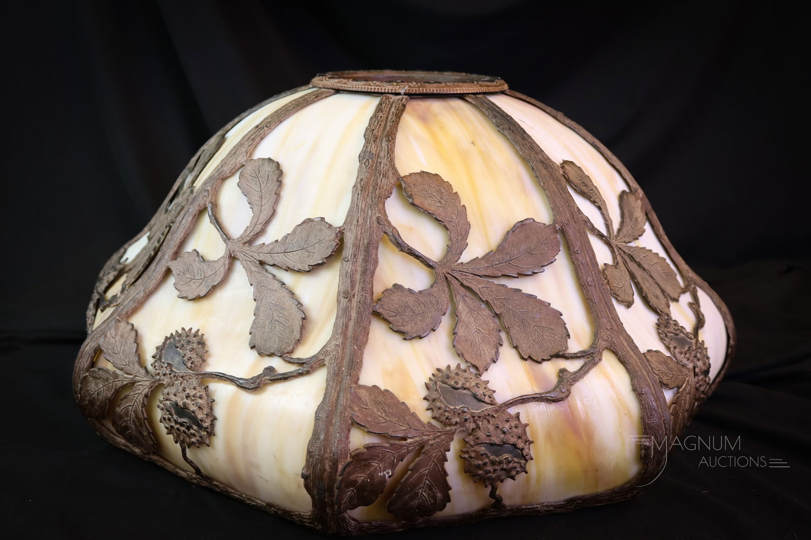 Antique Art Nouveau Slag Glass Overlay Table Lamp Shade: A choice find in an antique curved slag glass overlay lamp shade. This beautiful find is in untouched, original condition. The Art Nouveau shade features an overlay metalwork design of buckeyes or che