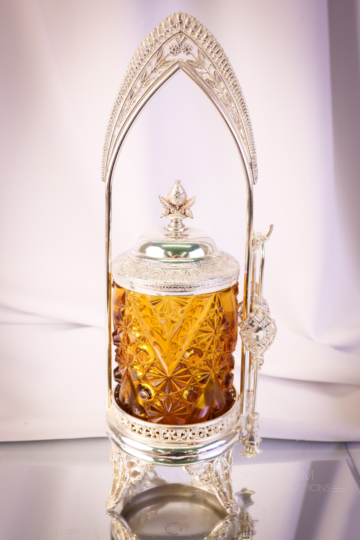 Albany Silverplate Victorian Daisy & Button Pickle Castor: A wonderful find in a Victorian pickle castor. This castor has an amber Daisy & Button pattern with "V" ornament jar. The frame is signed Albany silverplate. The castor measures 13" tall.
