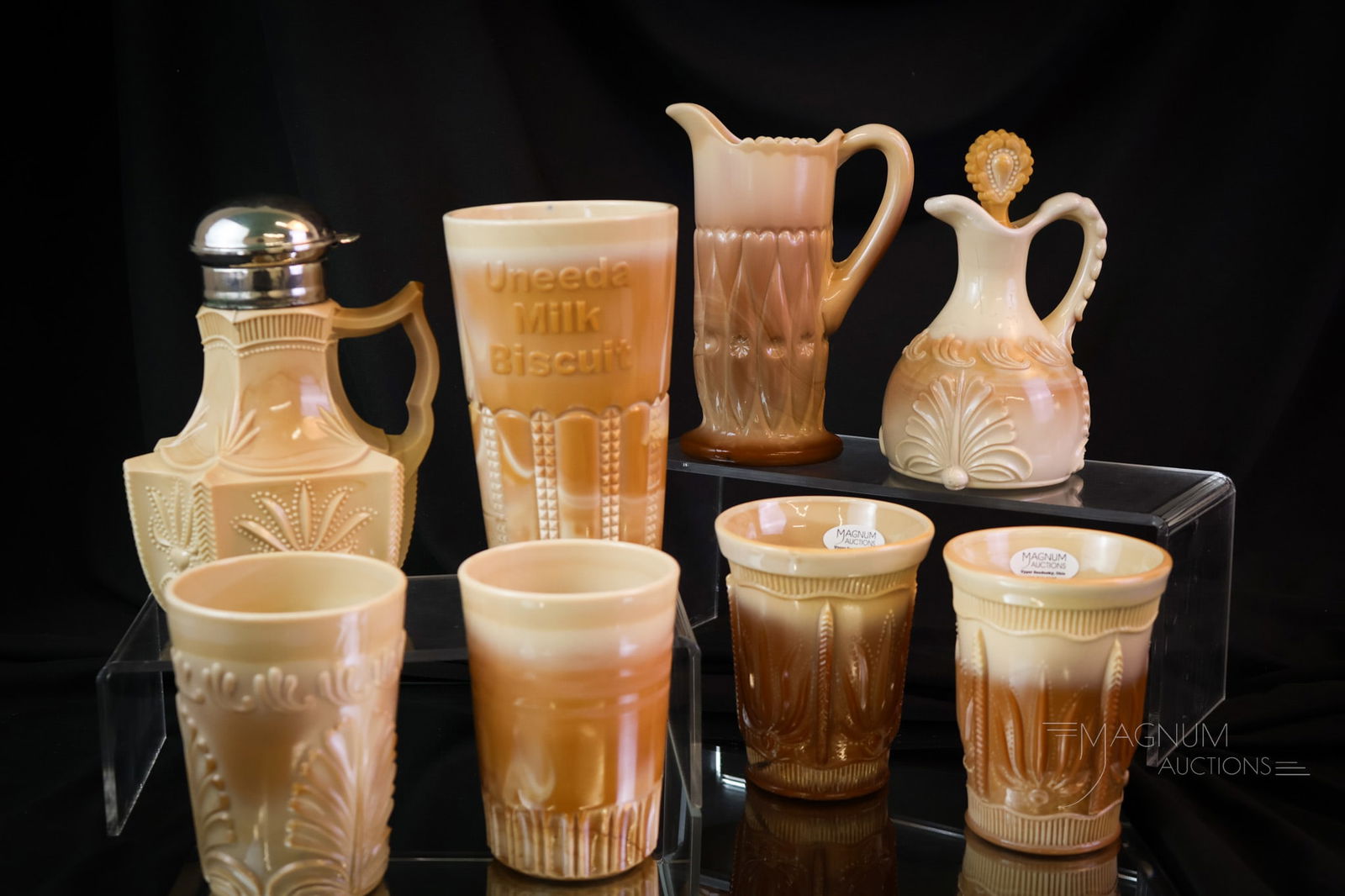 8 pc Lot Victorian Greentown Chocolate Glass: Eight finds for your collection shelf. This lot includes a Cactus pattern syrup and two tumblers. A leaf Bracket pattern cruet and tumbler. A Uneeda tumbler along with another tumbler and lastly, a Sh