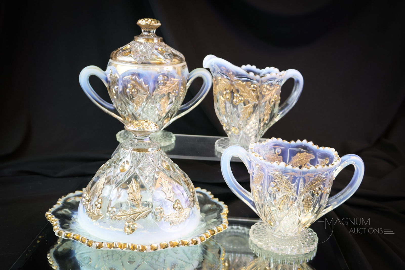 4 pc Northwood Paneled Holly Opalescent Victorian Table Set: A beautiful Northwood opalescent Paneled Holly Victorian glass table set. This set is decorated with brilliant gold. The tallest of the set measures 6 1/2". The flange of the butter base exhibits a ch