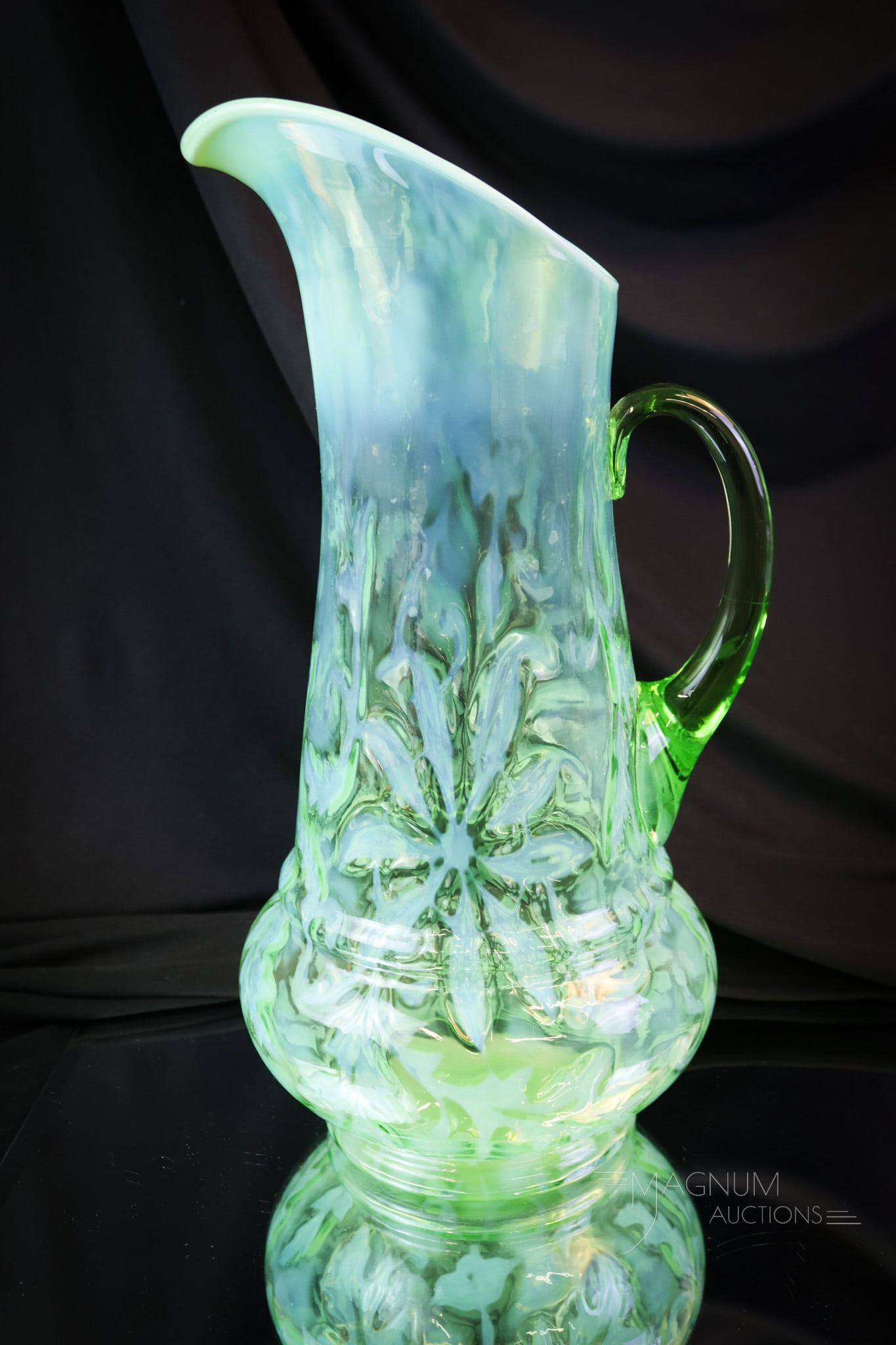 Northwood Green Opalescent VictorianGlass Poinsettia Tankard Pitcher: Another find in our line-up of Victorian opalescent glass. This is the Northwood Poinsettia pattern. Great coloriong and opal on this pitcher. This tankard measures 13" tall.