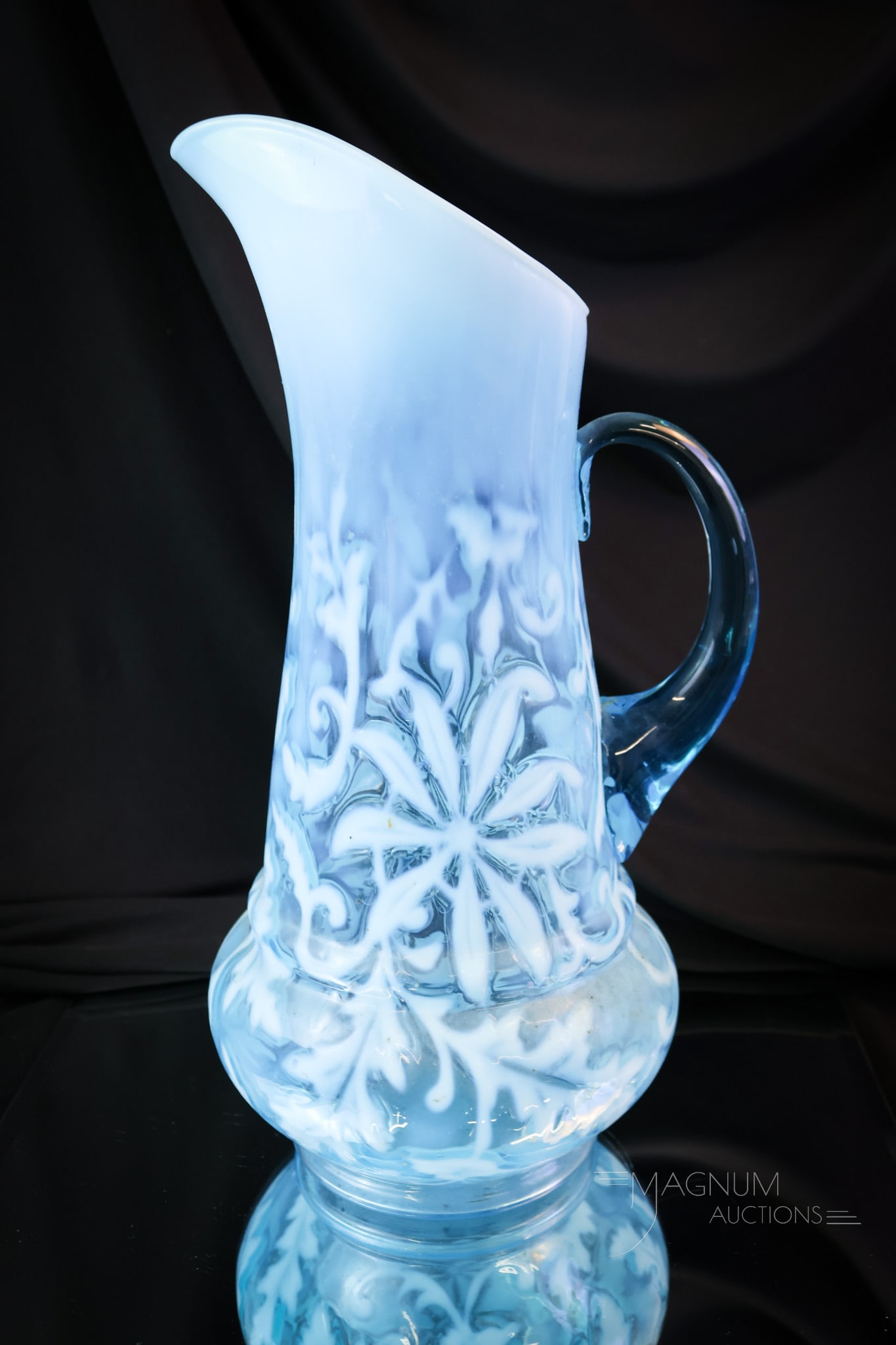 Northwood Blue Opalescent Victorian Glass Poinsettia Tankard Pitcher: Highly collectible Northwood Victorian opalescent glass tankard water pitcher. This one is in the Poinsettia pattern. A very nice example! The pitcher measures 13 1/2" tall.