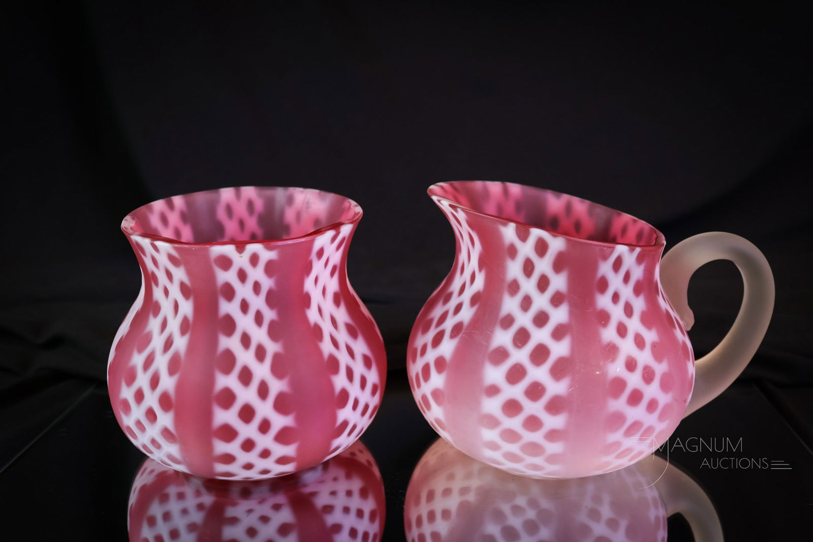 Consolidated Victorian Cranberry Opalescent Glass Criss Cross Glass: A beautiful lot of two pieces of Conoslidated Glass in the Criss Cross pattern. This lot offers a creamer and a spooner. Each has great color and a satin finish. The tallest measures 4".