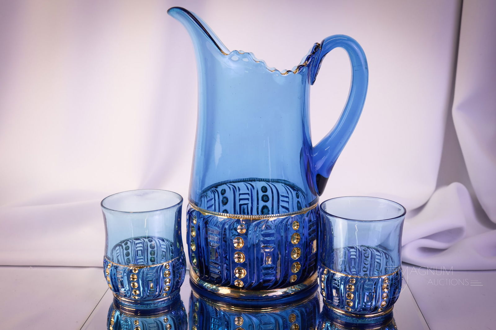 3 pc Riverside Blue & Gold Seedpod Victorian Glass Water Pitcher & Tumblers: A brilliant blue Riverside gilt decorated water pitcher and two tumblers. This set is so pretty. You'll just have to bid on it. The tankard pitcher measures 10 3/4" tall.