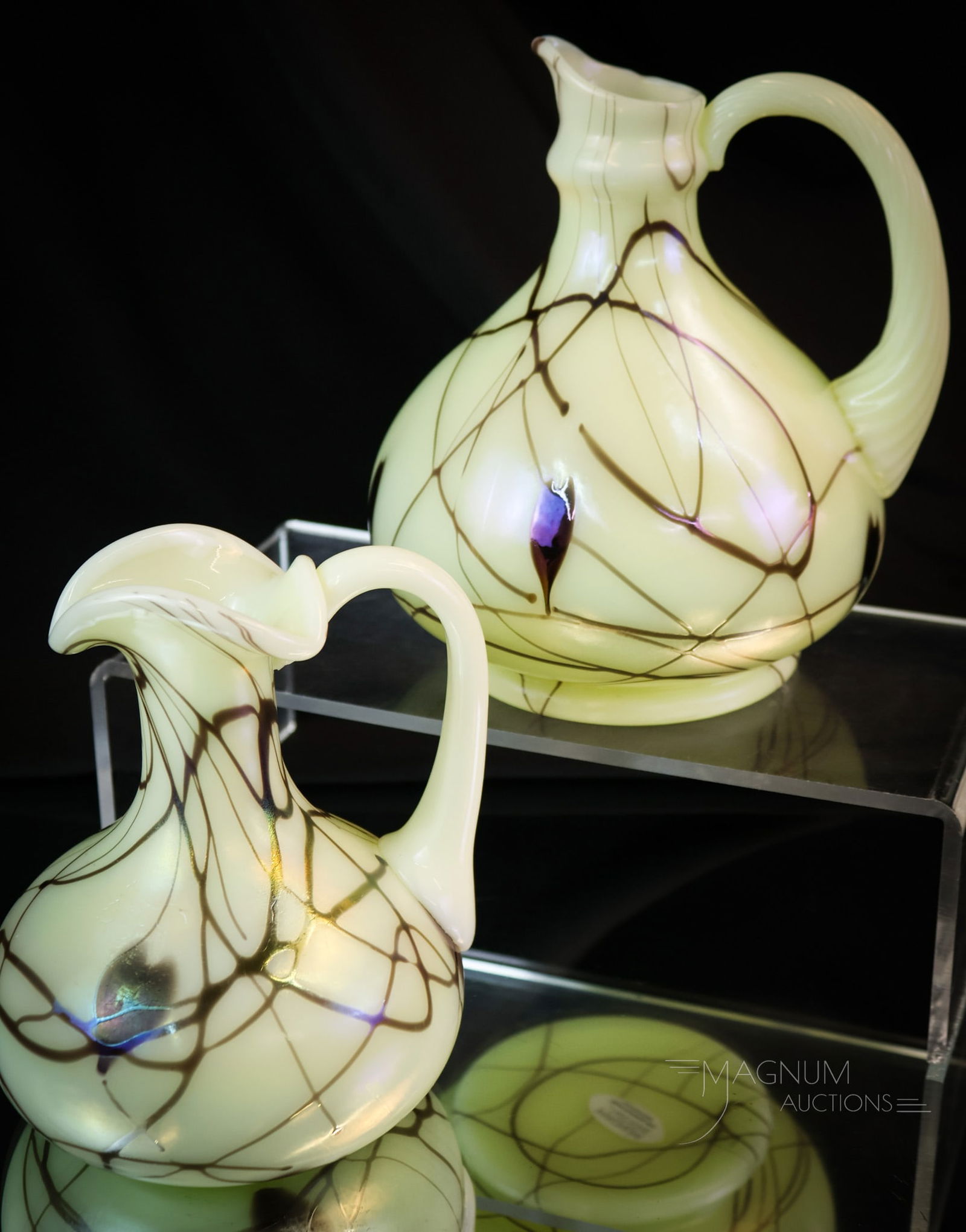2 pc Lot Fenton Uranium Custard Glass Hanging Hearts Cruets: Two simply marvelous finds in Fenton uranium-rich custard art glass cruets. Each cruet has hanging heart decoration. Each is also marked "Fenton 1976". The tallest measures 6". SHIPPING NOTICE: If you