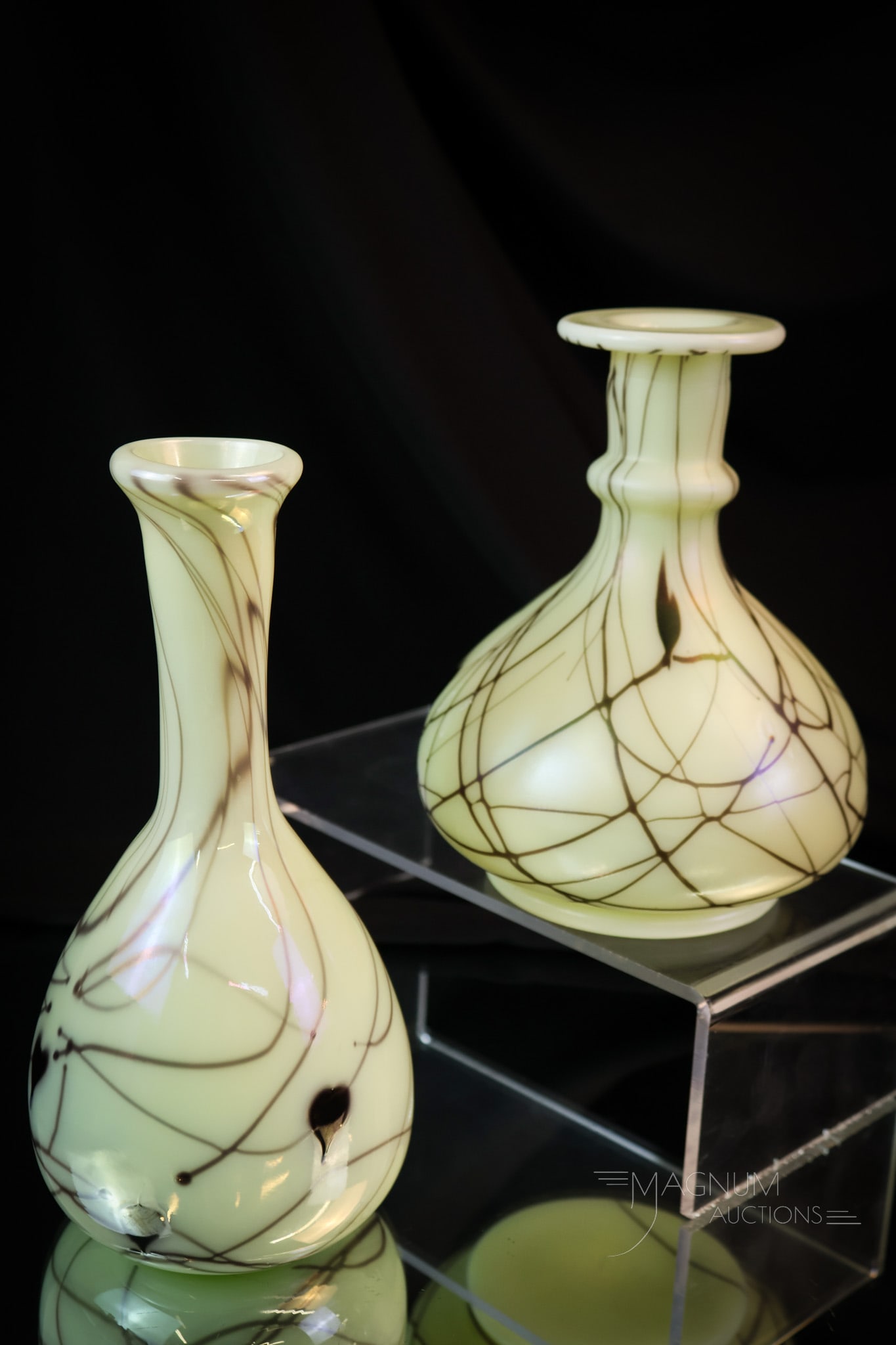 2 pc Lot Fenton Uranium Custard Art Glass Hanging Hearts Barber Bottles: Two sleek finds in Fenton uranium-rich custard art glass. These are two uniquely shaped barber bottles with Hanging Heart decoration. The example with the ring-neck mold bottle is marked "Fenton 1976"