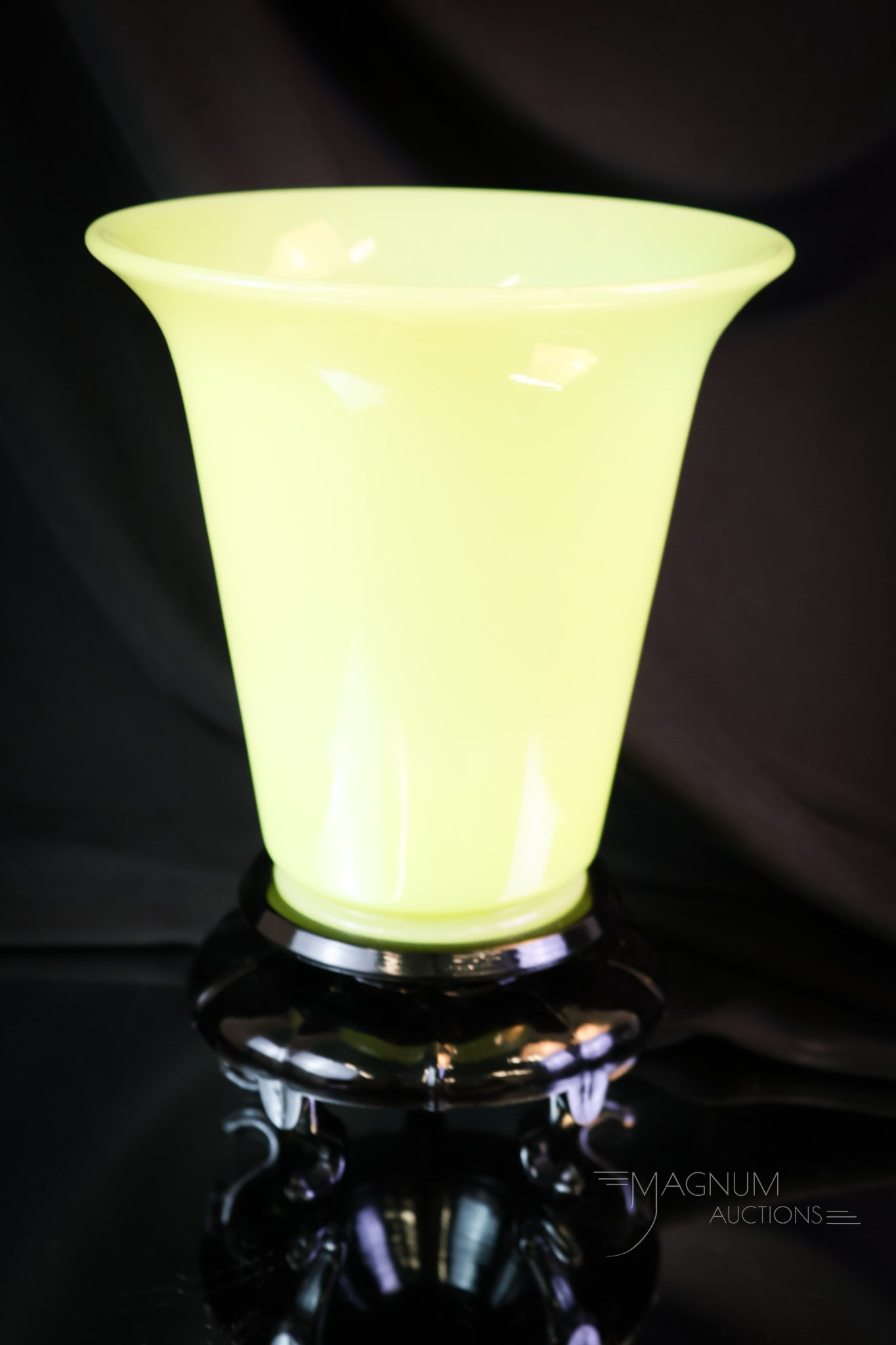 Fenton Uranium Art Glass Chinese Yellow Vase: A lovely Fenton Art Glass Chinese yellow uranium-rich vase on an original black glass stand. The vase glows brightly under black light. The black base exhibits a fleabite chip on one corner point. The