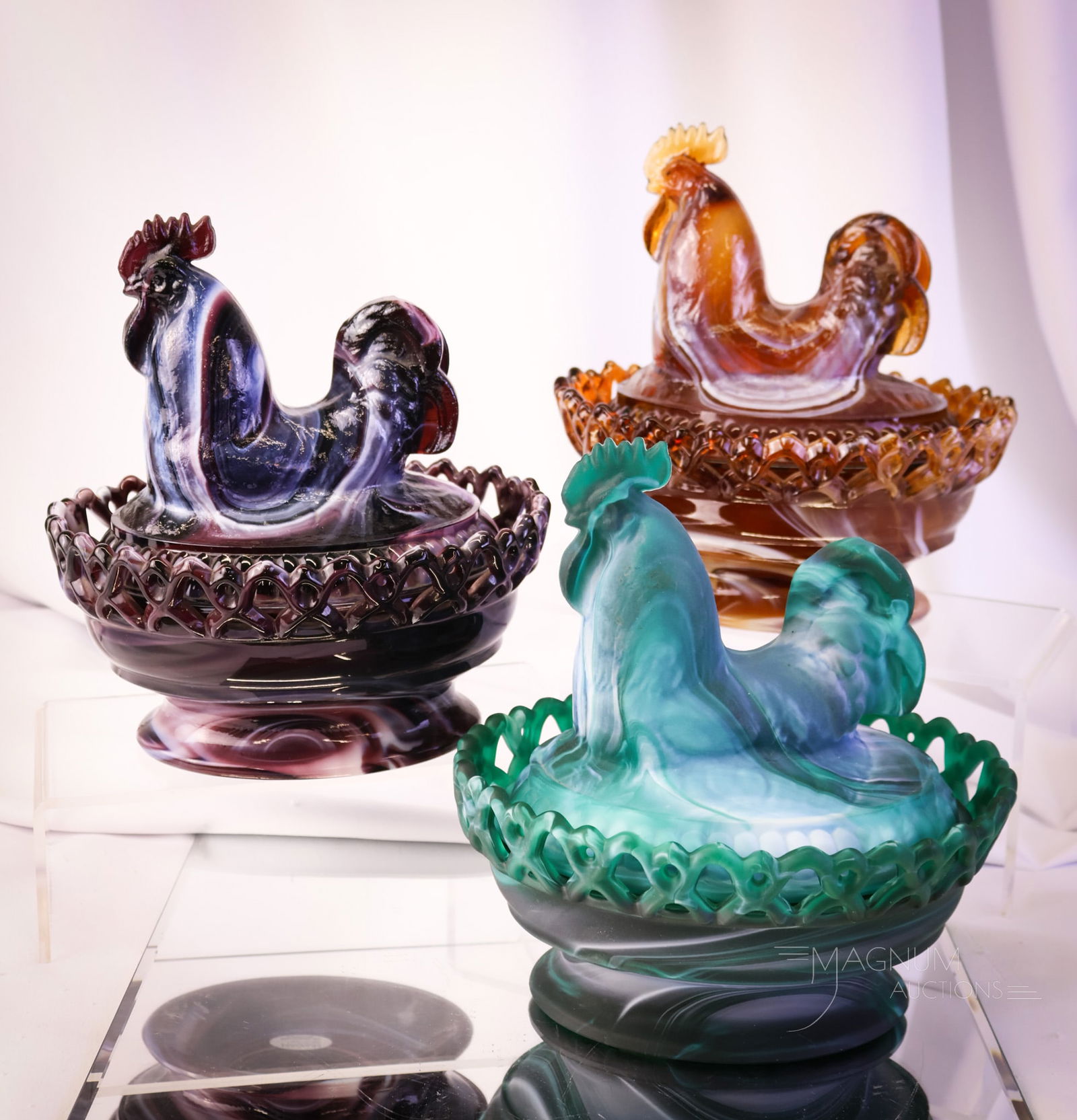 3 pc Lot Imperial Slag Art Glass Covered Dishes: Three unique finds in Imperial slag glass-covered rooster dishes. One in carmel, one in purple, and one in green satin glass. The tallest measures 8". SHIPPING NOTICE: If you choose not to utilize the