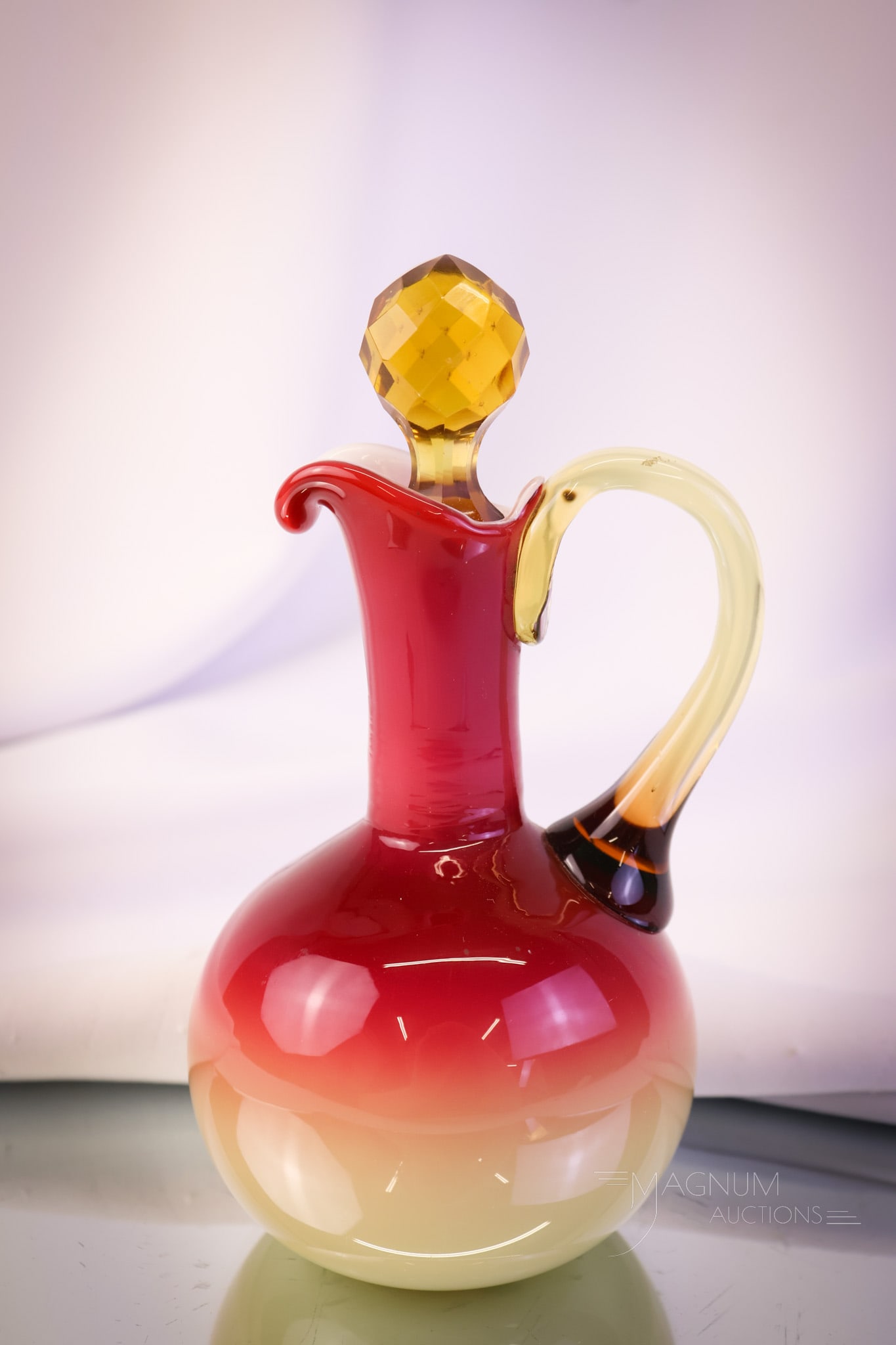 Art Glass Peachblow Cased Plated Cruet: A beautiful example of a plated or cased peachblow art glass cruet. This cruet has gorgeous coloring and a matching amber faceted glass stopper. The cruet measures 6 1/2" tall. SHIPPING NOTICE: If you