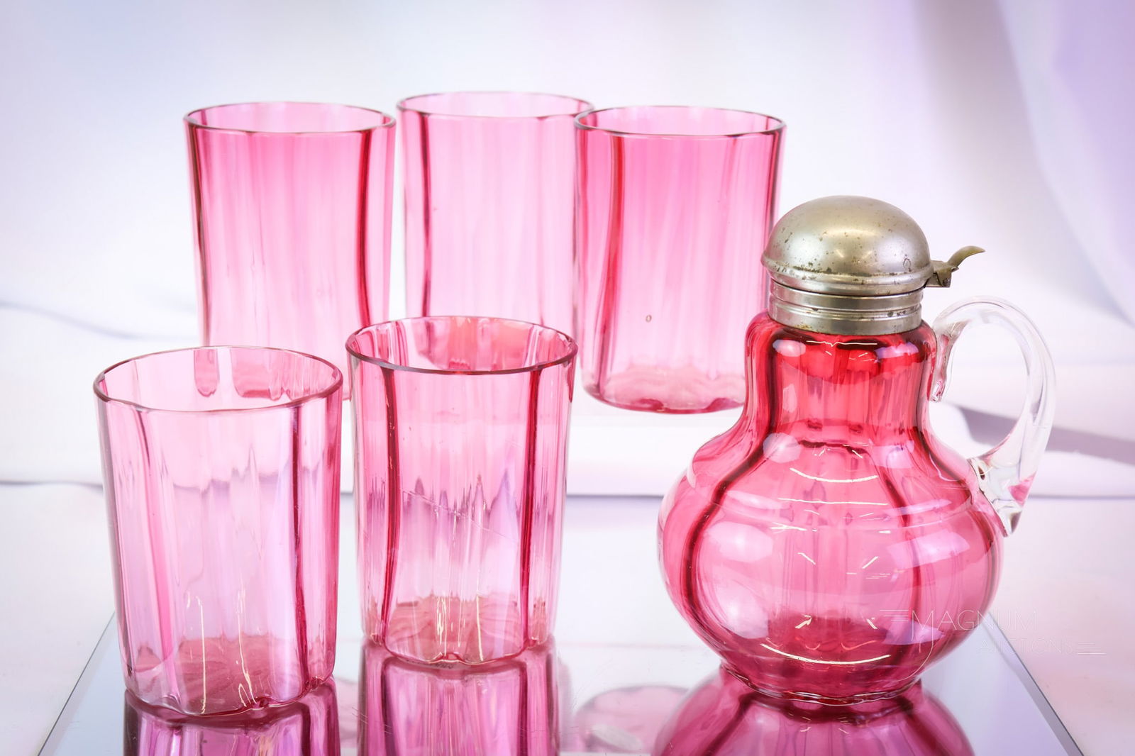 6 pc Lot Hobbs Victorian Cranberry Glass: Six tempting pleasures in Hobbs cranberry Victorian glass. This lot consists of a syrup and five tumblers. The tallest measures 5 3/4" tall. SHIPPING NOTICE: If you choose not to utilize the LiveAucti