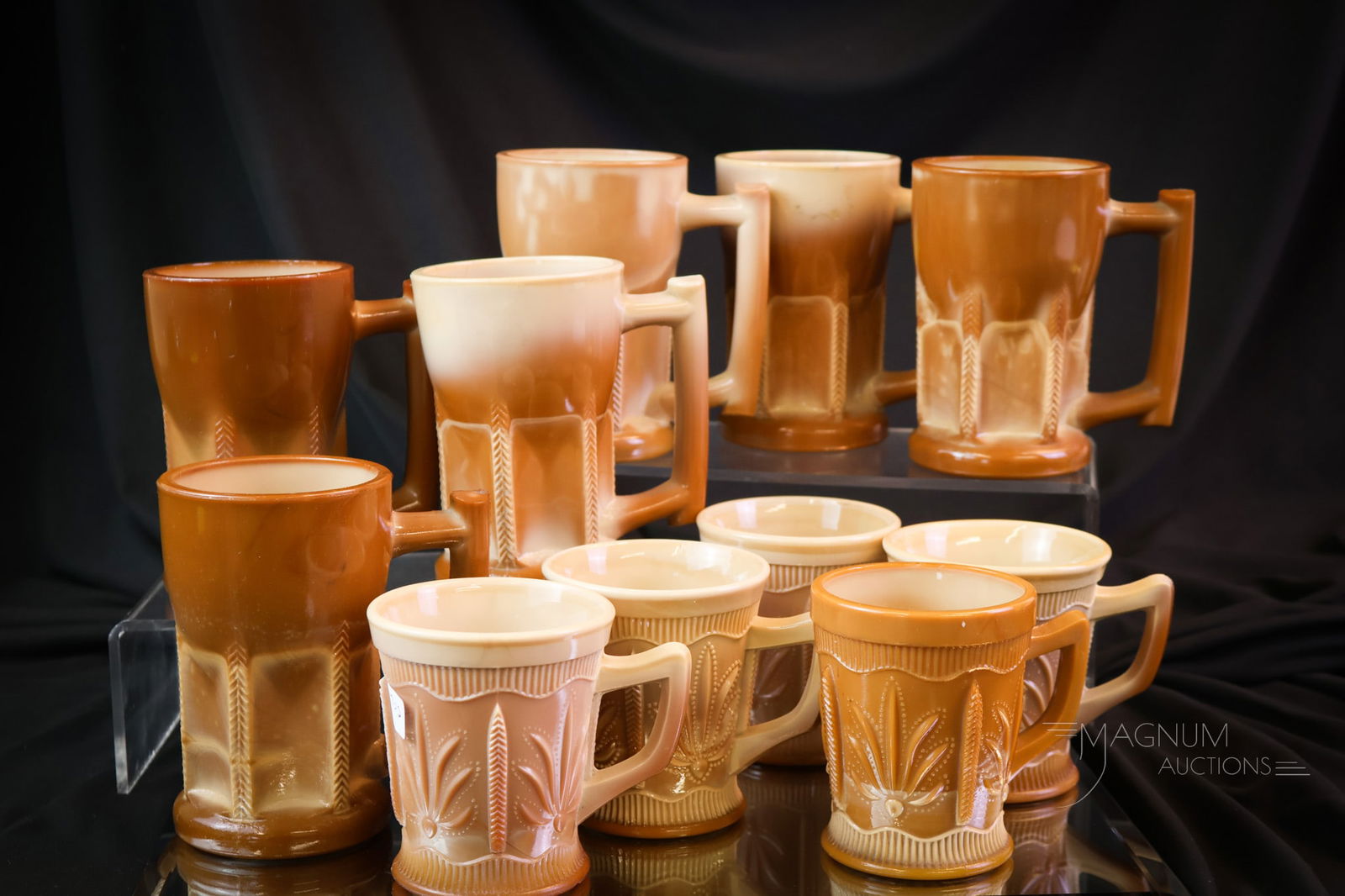 11 pc Lot Victorian Greentown Chocolate Glass: A more than generous lot of Victorian Greentown chocolate glass for your bidding pleasure. This lot includes six Herringbone Buttress pattern mugs and five Cactus pattern mugs. The tallest of the lot