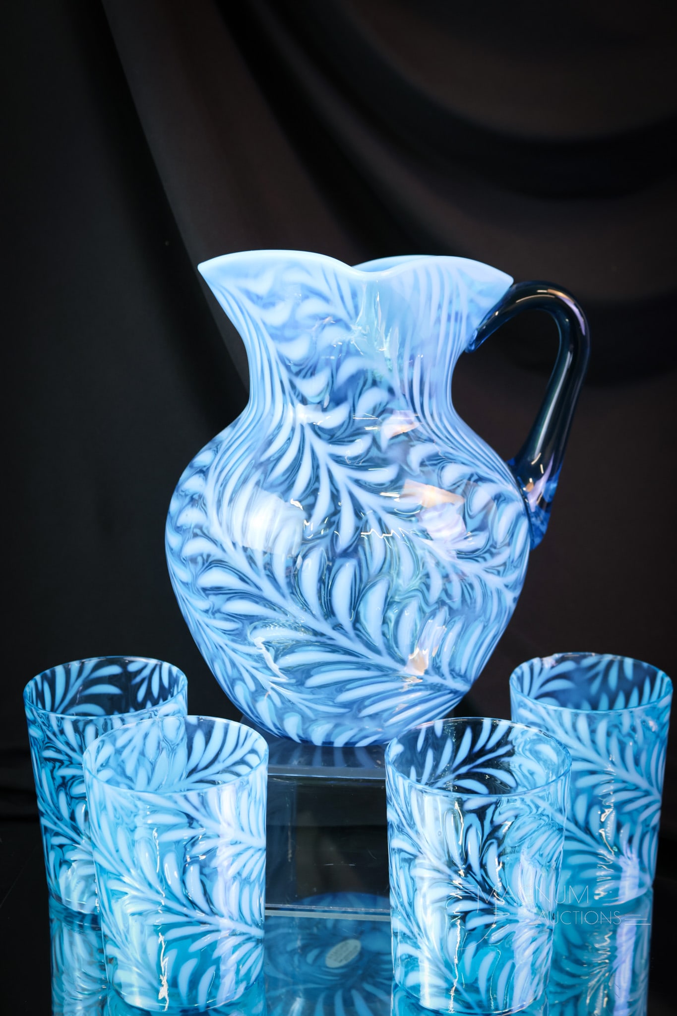 4 pc Blue Opalescent Victorian Glass Fern Water Set: A striking blue opalescent Fern pattern water set. This set features a pitcher and three tumblers. The tallest of the set measures 8 1/2". One tumbler exhibits a rim chip. SHIPPING NOTICE: If you choo
